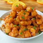 Chinese Orange Chicken that is better than take-out. How to make ORANGE CHICKEN at home with a sweet orange sauce. www.modernhoney.com