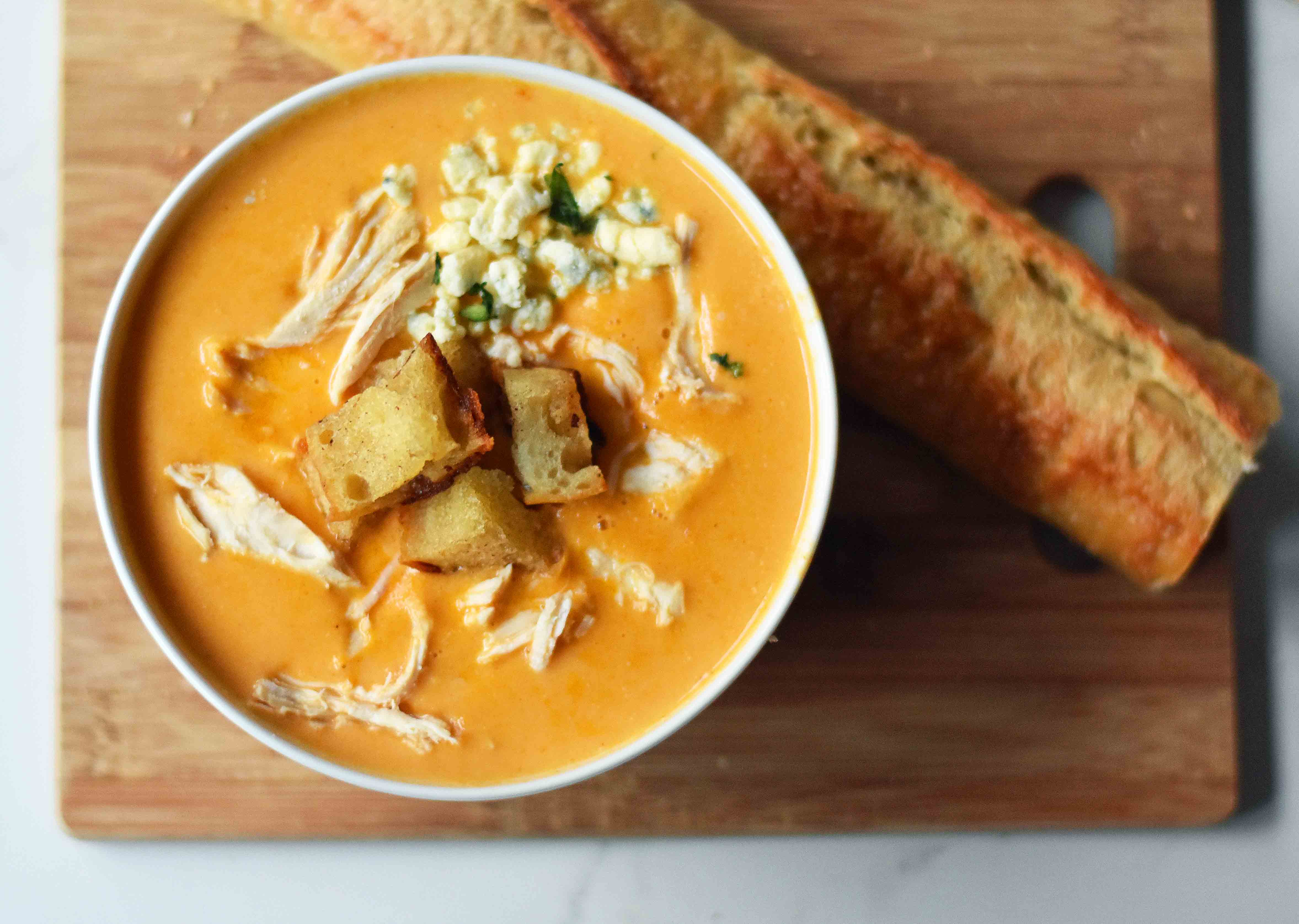 Creamy Buffalo Chicken Soup. All of the flavor of chicken wings in one soup. A tangy, creamy, and spicy buffalo chicken soup. www.modernhoney.com