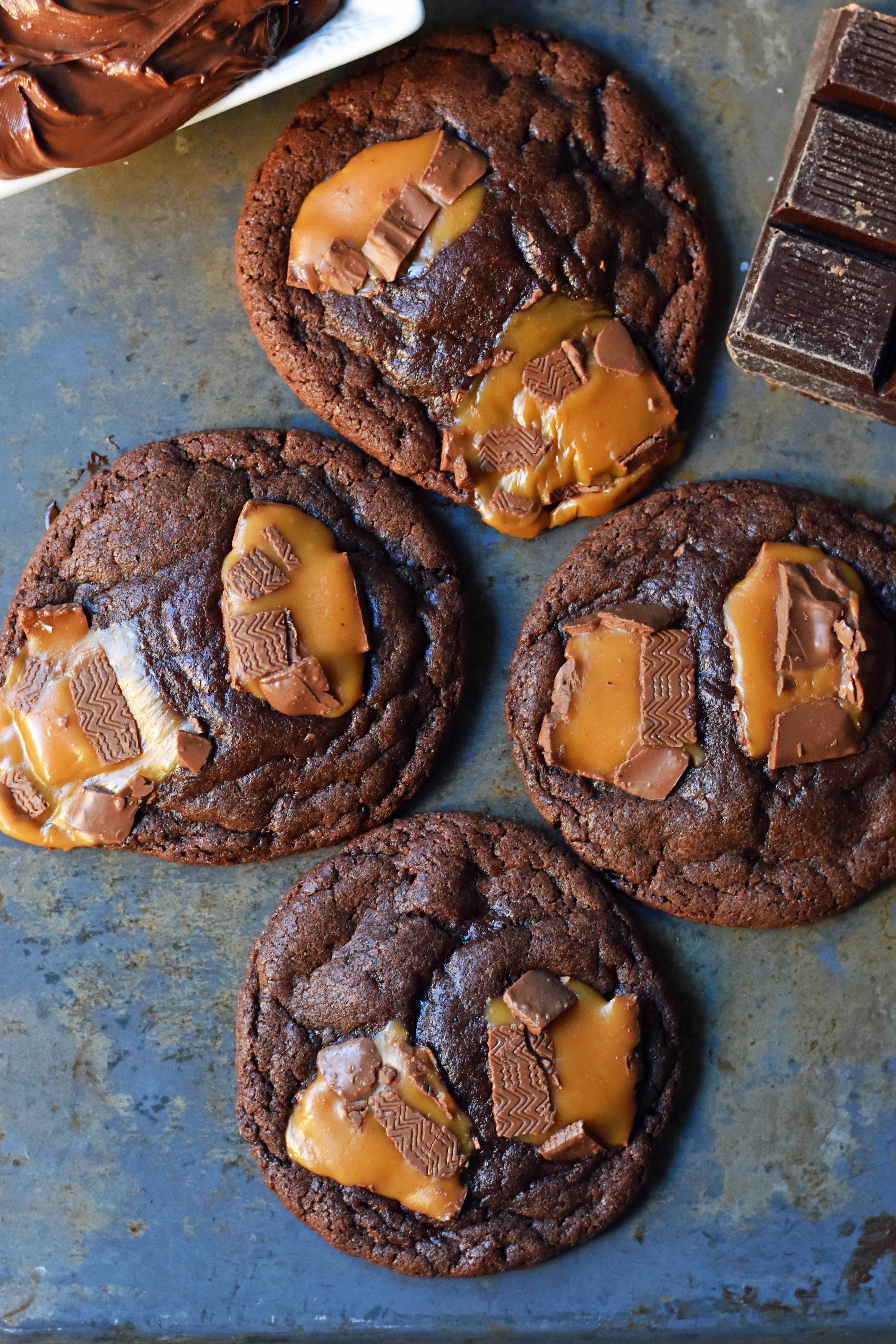 Chocolate Nutella Caramel Cookies. Soft chewy chocolate cookies with Nutella chocolate hazelnut spread baked with caramel Milky Way Bars. The best chocolate Nutella caramel cookie. www.modernhoney.com