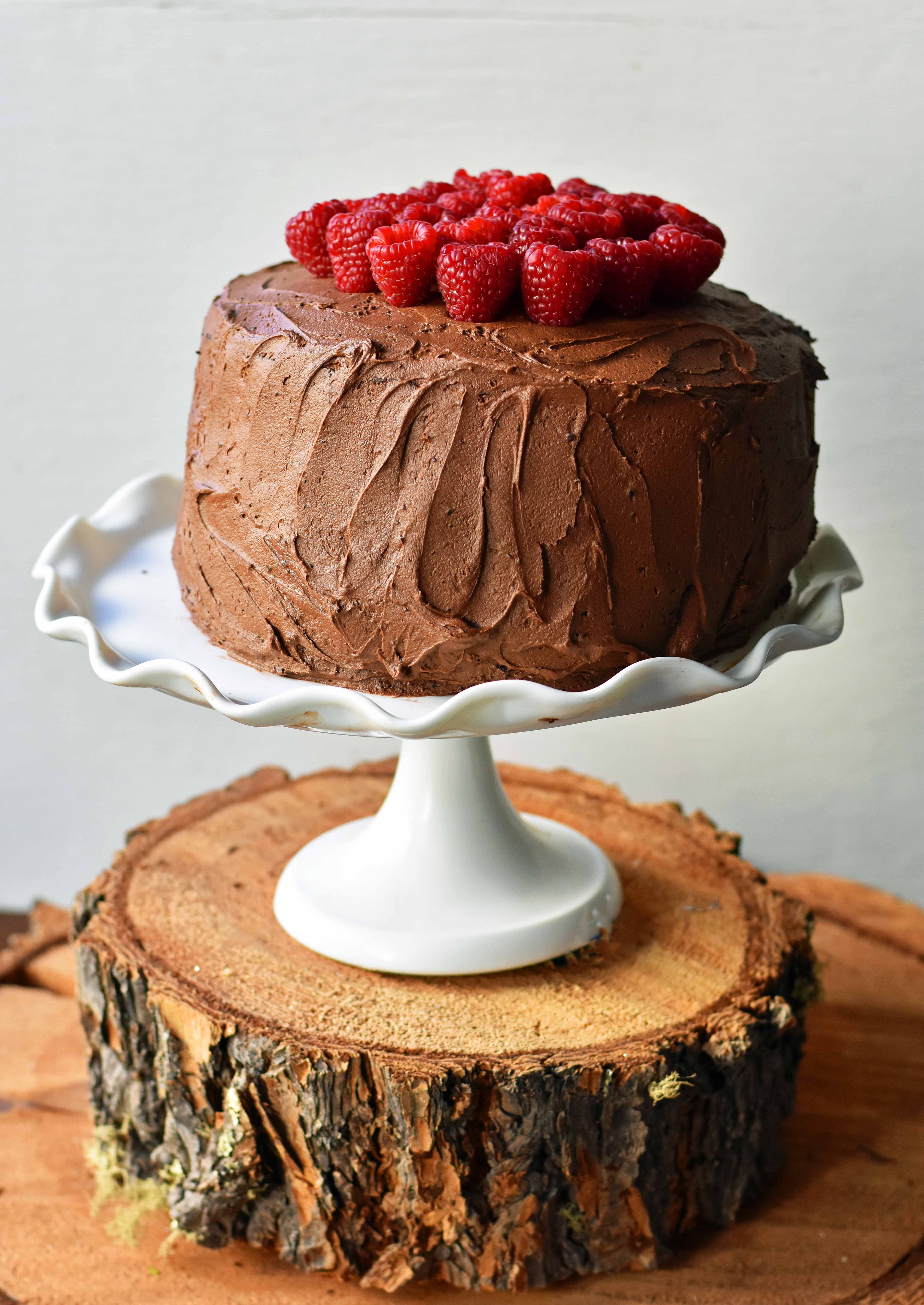 Rich chocolate cake layered with whipped cream cheese raspberry filling, topped with creamy chocolate frosting and fresh raspberries. Homemade BEST EVER Chocolate Cake with sweet whipped cream cheese raspberry filling topped with chocolate buttercream and raspberries. www.modernhoney.com
