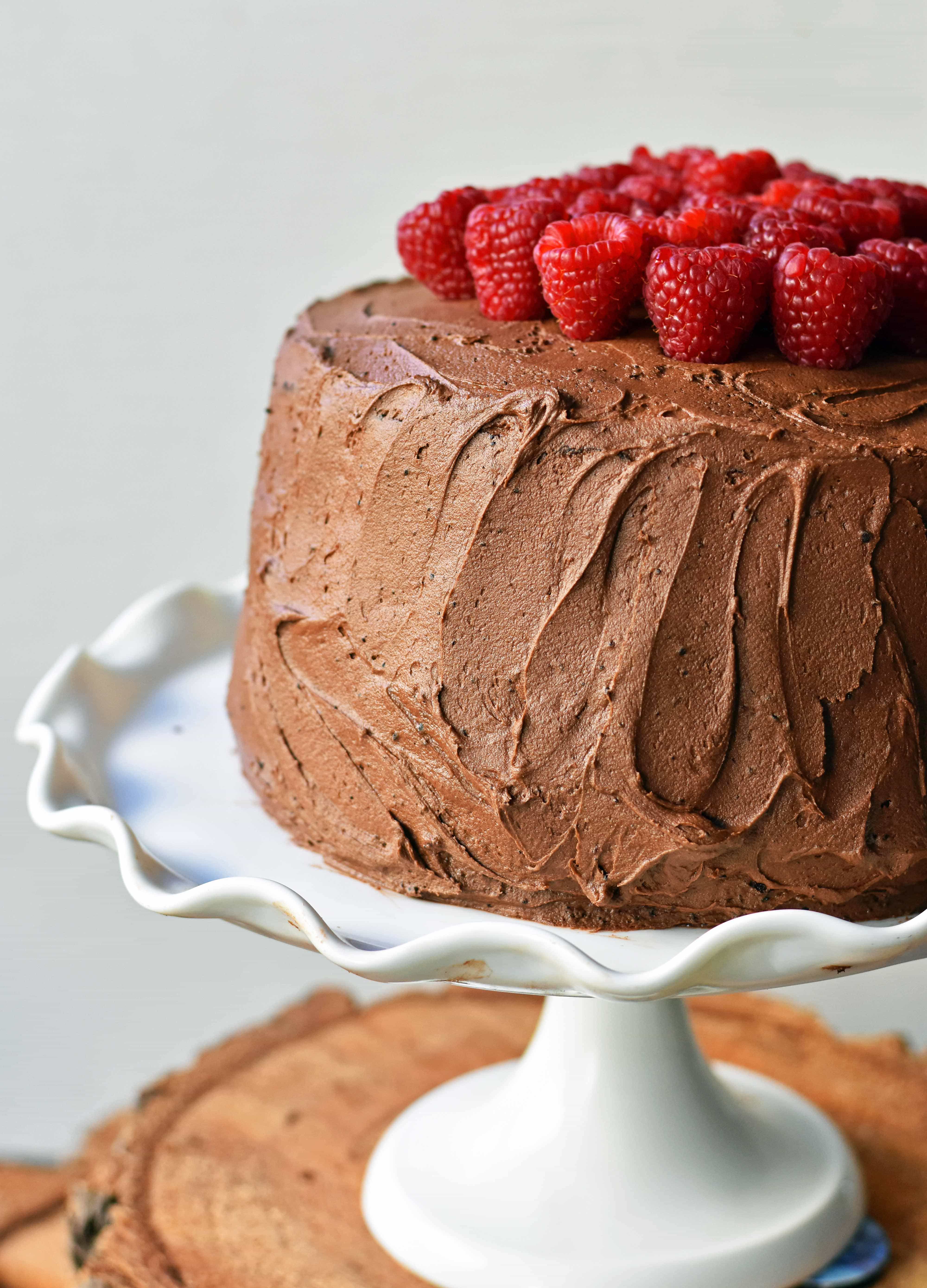Rich chocolate cake layered with whipped cream cheese raspberry filling, topped with creamy chocolate frosting and fresh raspberries. Homemade BEST EVER Chocolate Cake with sweet whipped cream cheese raspberry filling topped with chocolate buttercream and raspberries. www.modernhoney.com
