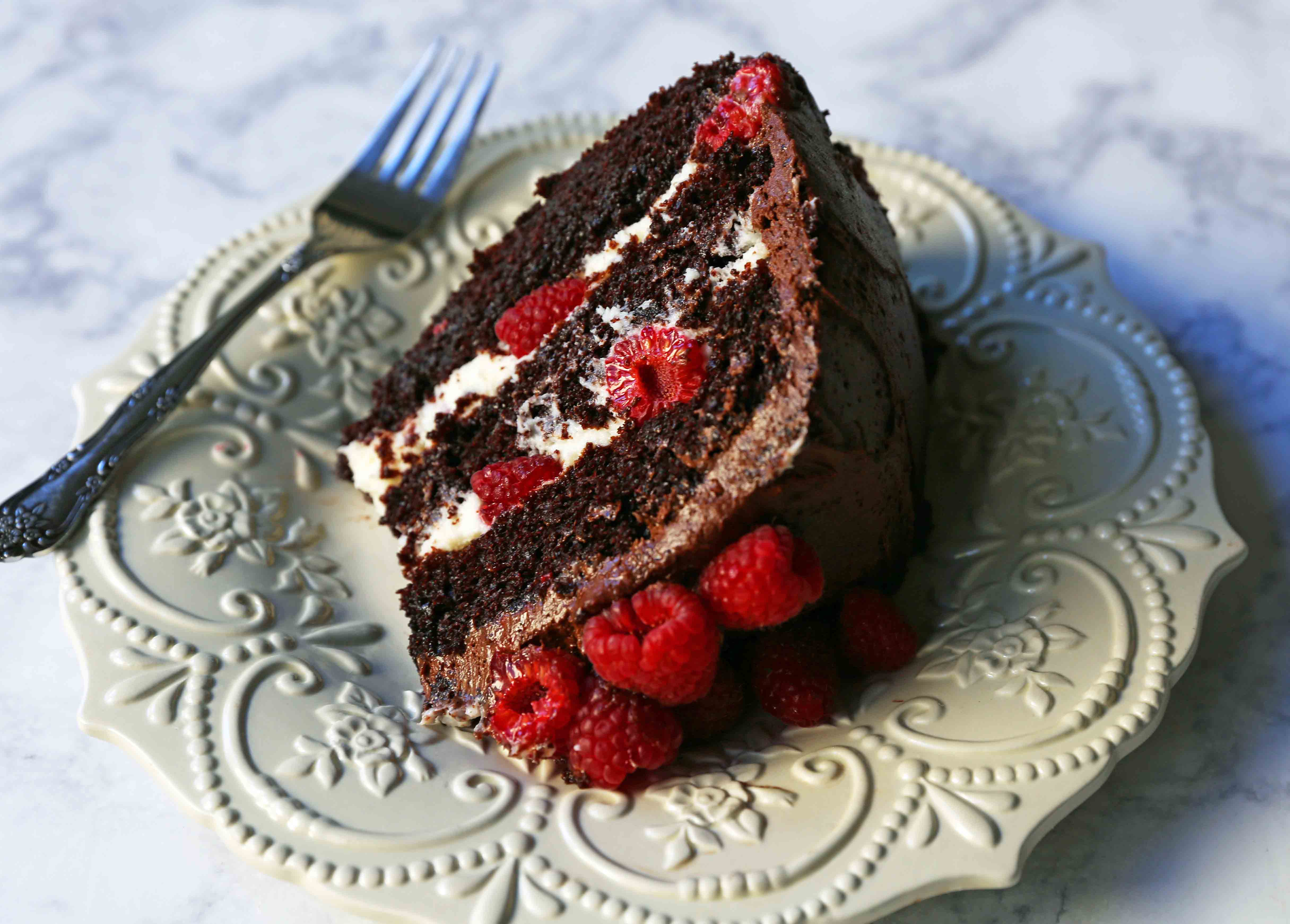 Chocolate Raspberry Cake. Moist chocolate cake with sweet cream cheese filling, fresh raspberries, and rich chocolate frosting. www.modernhoney.com #chocolateraspberrycake #cake #cakes #cakerecipe