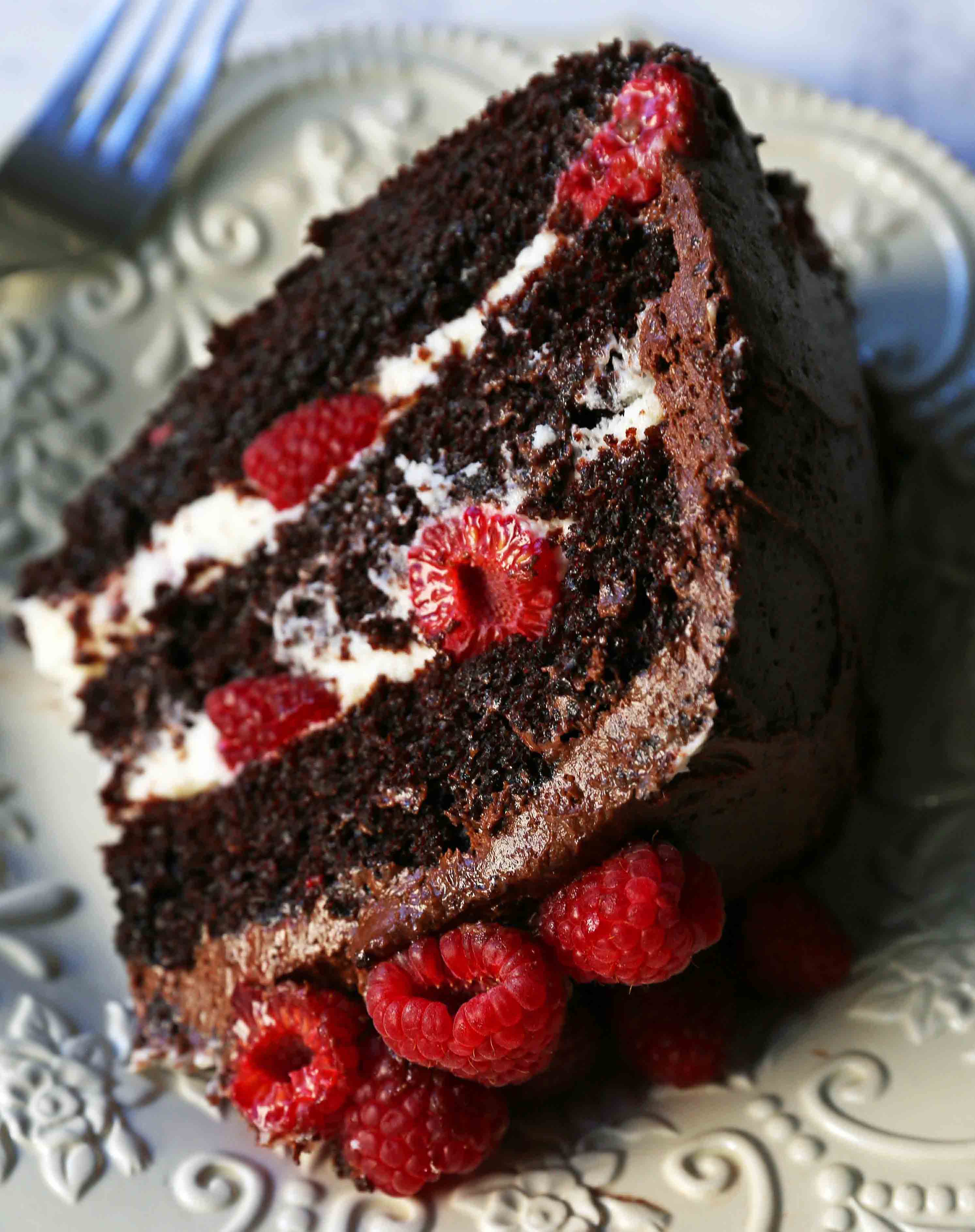 Chocolate Raspberry Cake. Moist chocolate cake with sweet cream cheese filling, fresh raspberries, and rich chocolate frosting. www.modernhoney.com #chocolateraspberrycake #cake #cakes #cakerecipe