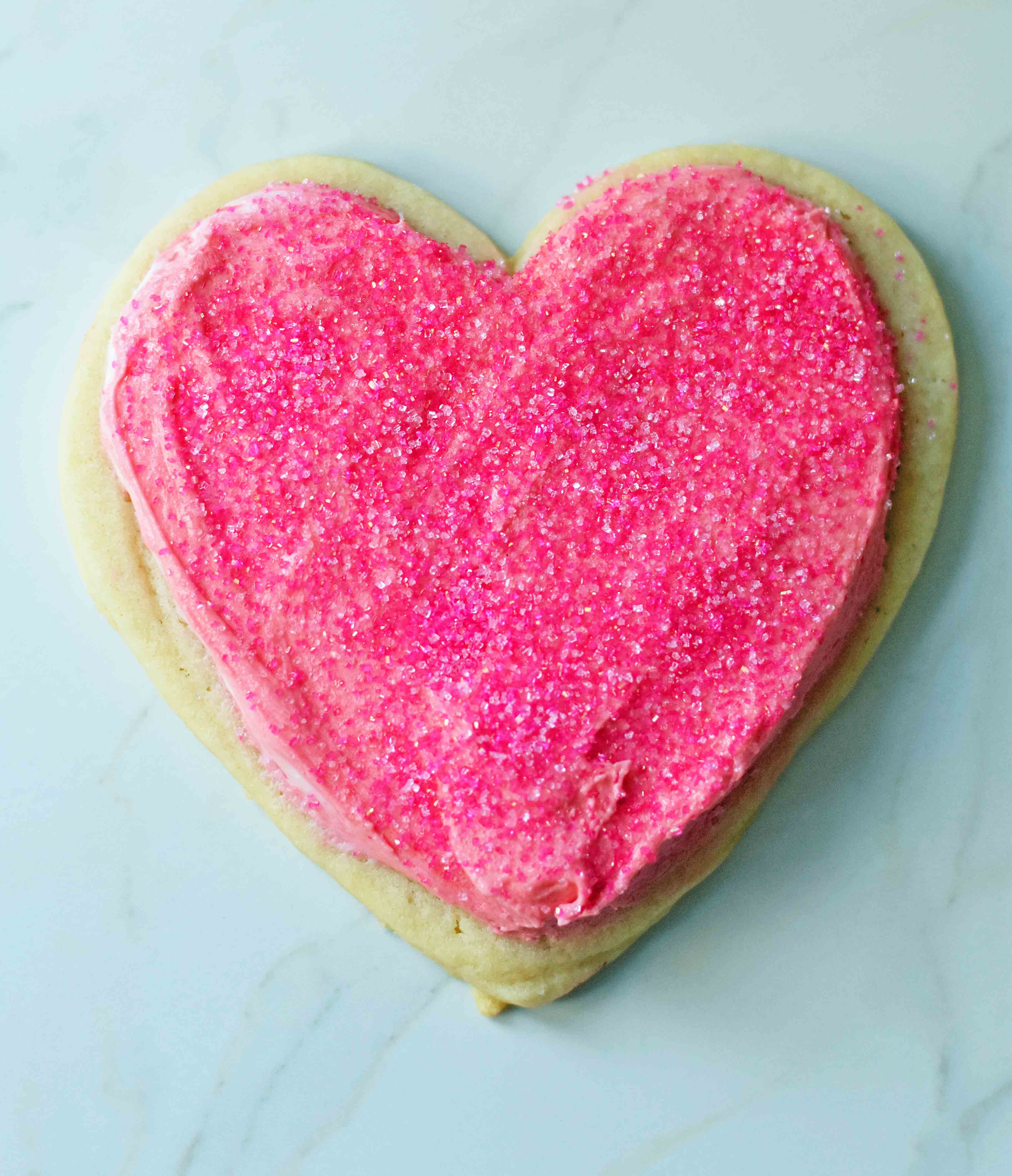 Soft Chewy Sugar Valentine's Day Cookie. How to make perfect heart shaped cookies with vanilla cream cheese buttercream frosting. www.modernhoney.com