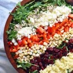 Chopped Salad with fresh arugula, dried cranberries, crunchy red peppers, feta cheese, sweet corn, and couscous tossed with a creamy basil dressing. A Wildflower copycat recipe. www.modernhoney.com