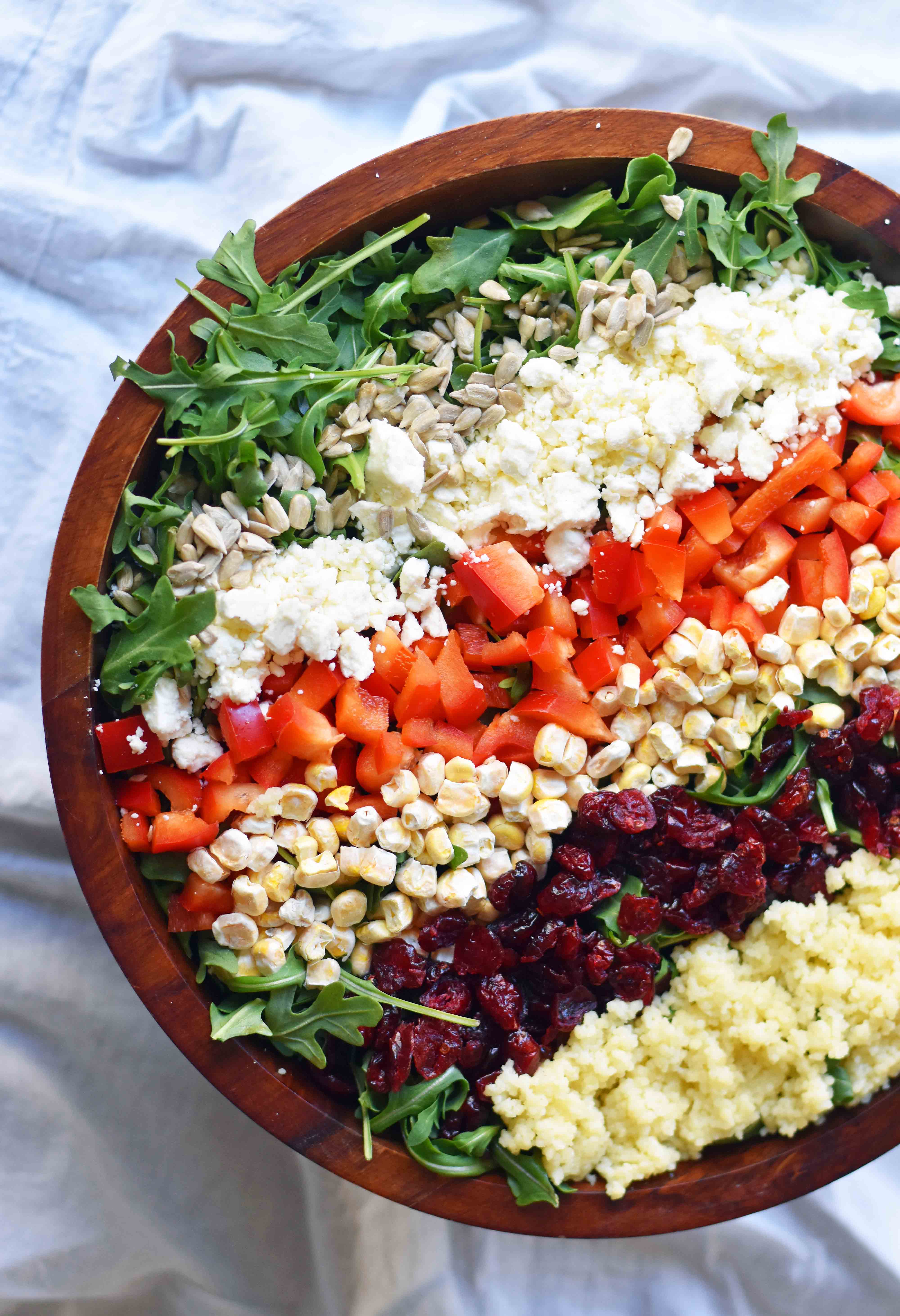 Chopped Salad with fresh arugula, dried cranberries, crunchy red peppers, feta cheese, sweet corn, and couscous tossed with a creamy basil dressing. 