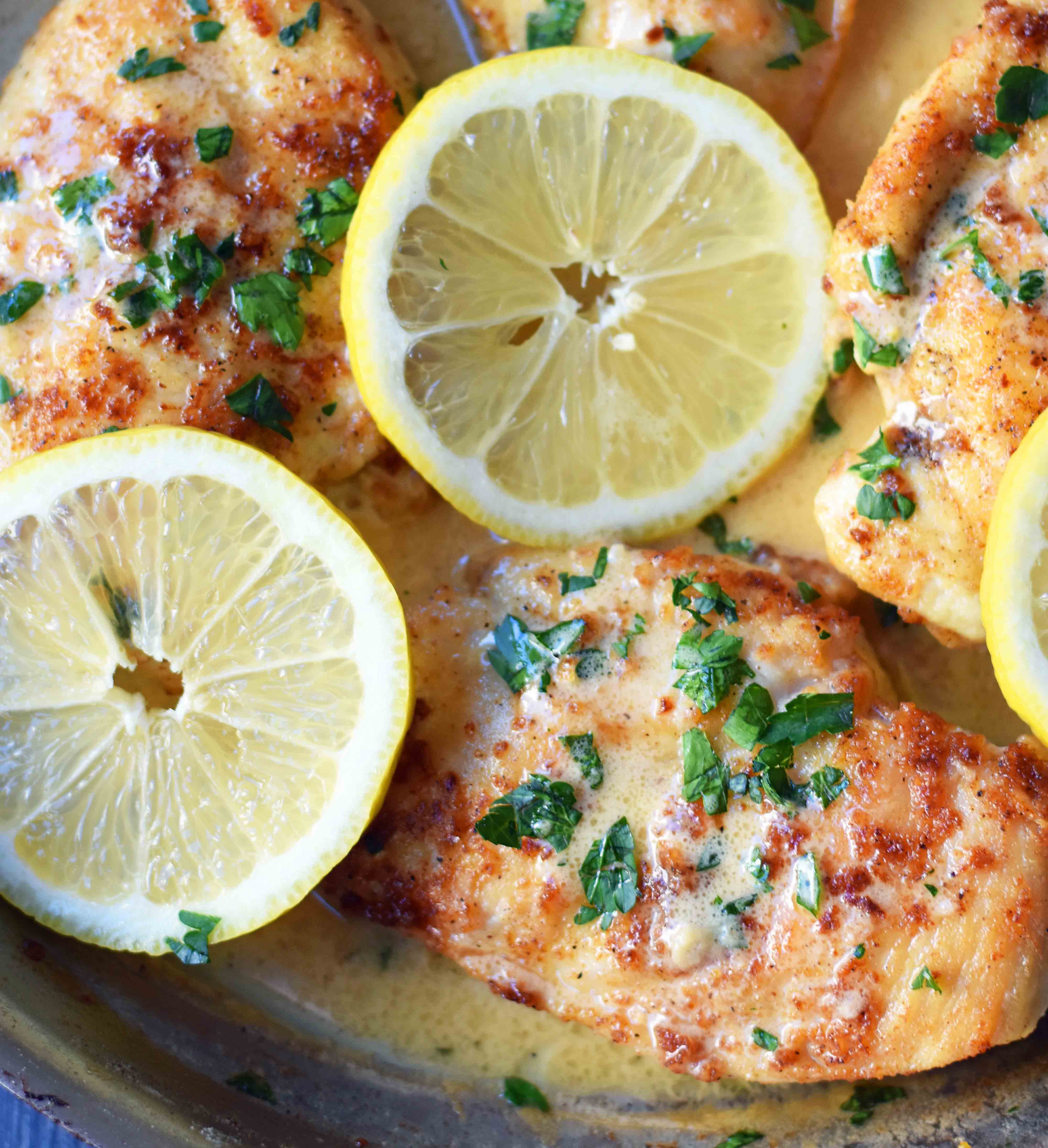 This simple 20-minute Skillet Lemon Butter Chicken is a pan-fried chicken in a silky lemon butter sauce. Chicken sauteed in butter and olive oil and topped with a creamy lemon butter sauce. An easy weeknight dinner that your whole family will love! www.modernhoney.com