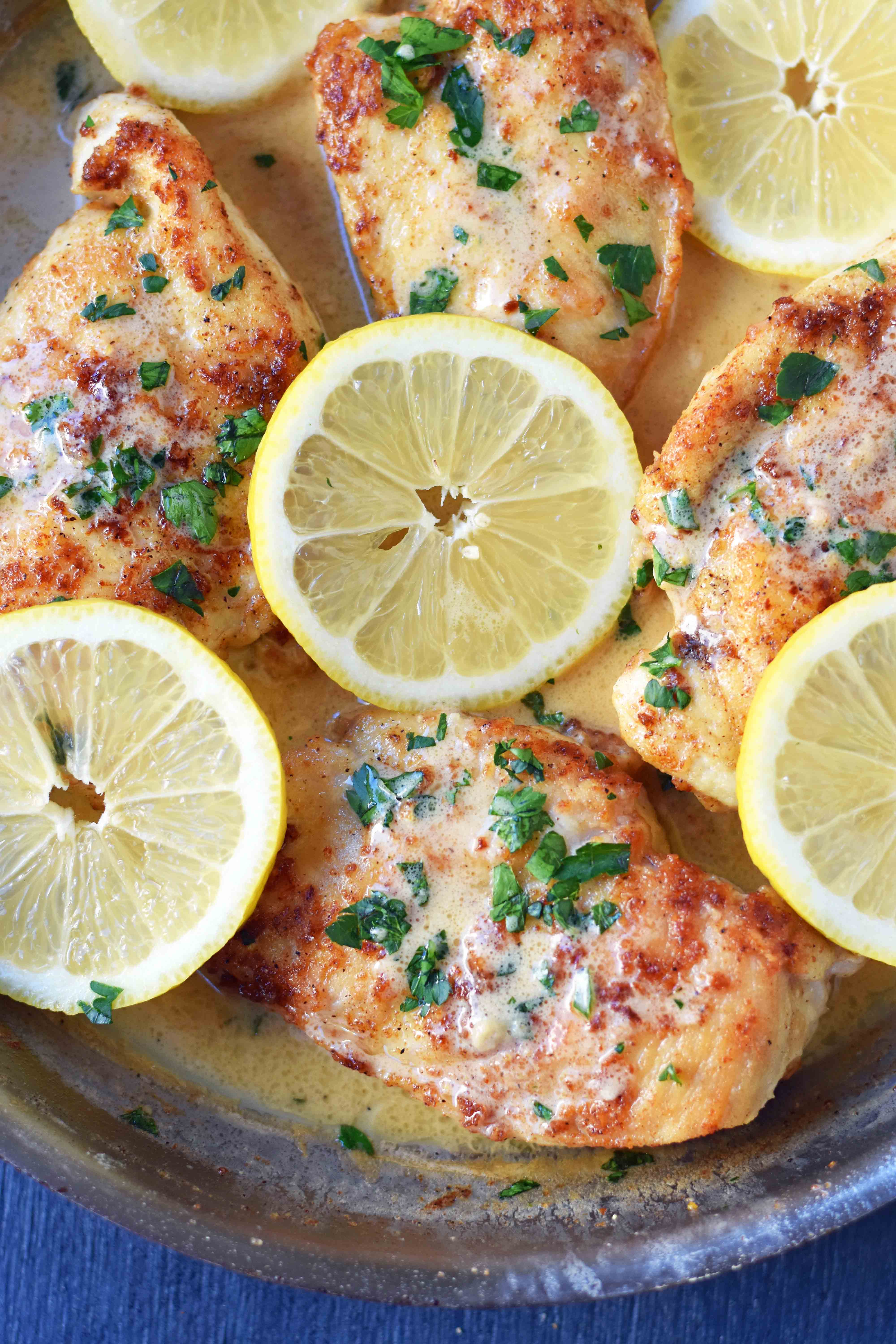 This simple 20-minute Skillet Lemon Butter Chicken is a pan-fried chicken in a silky lemon butter sauce. Chicken sauteed in butter and olive oil and topped with a creamy lemon butter sauce. An easy weeknight dinner that your whole family will love! www.modernhoney.com