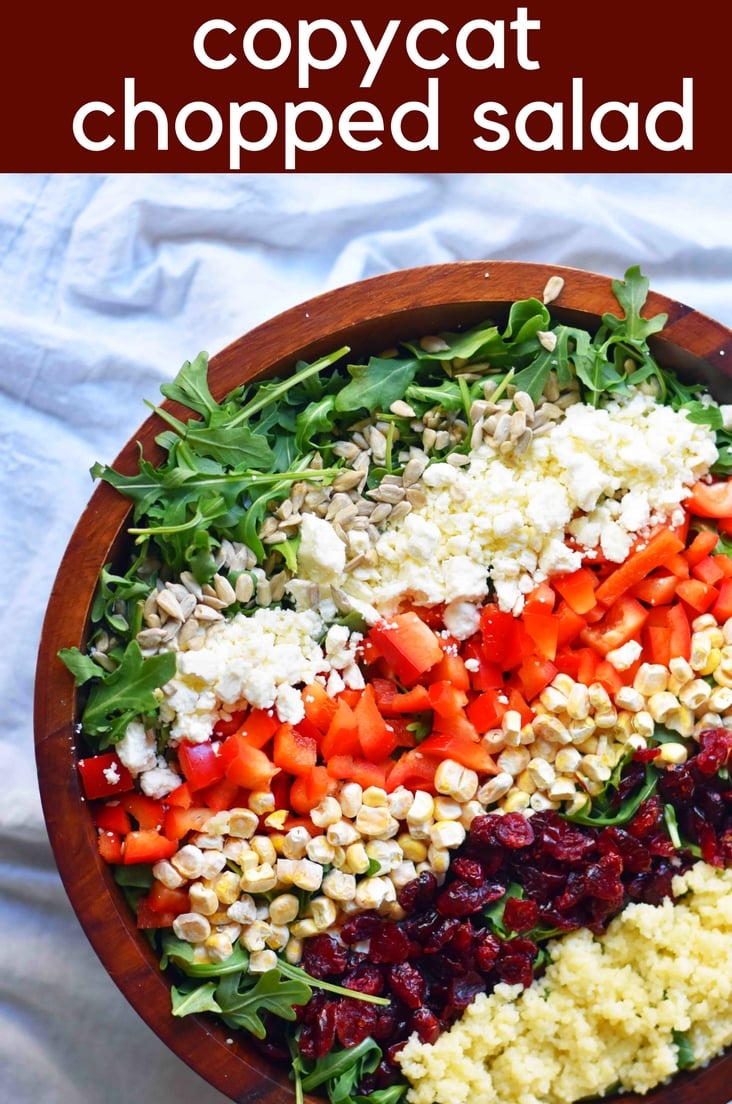 Chopped Salad with fresh arugula, dried cranberries, crunchy red peppers, feta cheese, sweet corn, and couscous tossed with a creamy basil dressing. www.modernhoney.com