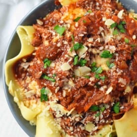 Slow Cooker Instant Pot Beef Ragu. This braised shredded beef ragu with pappardelle pasta can be made in a slow cooker or instant pot pressure cooker. It makes the most tender, flavorful beef in a rich, velvety sauce. It is the ultimate comfort meal in a bowl! This Beef Ragu can be put on top of spiralized vegetables, mashed potatoes, or polenta for a gluten-free dinner. www.modernhoney.com