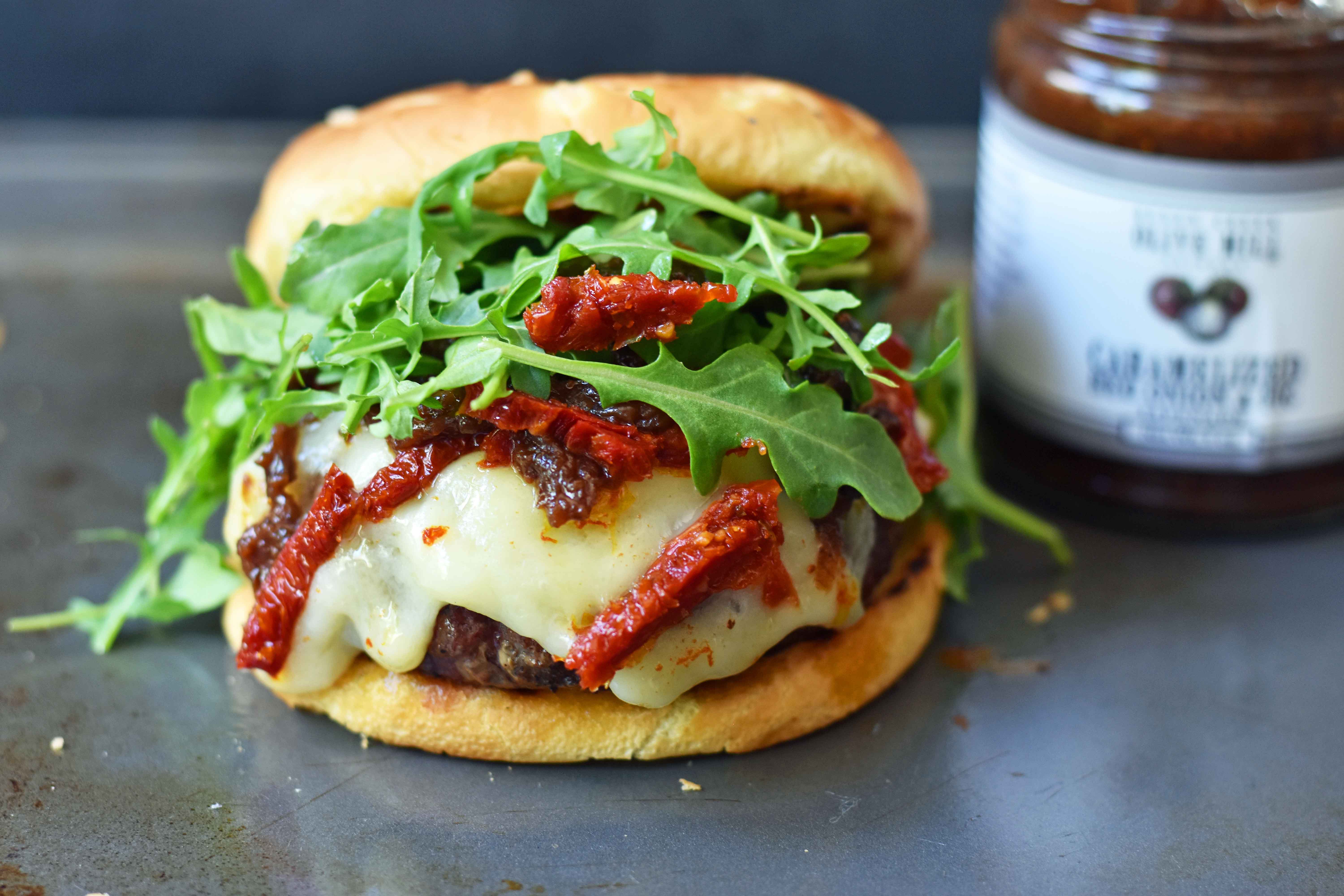 Brie Burger with Caramelized Onions and Sundried Tomatoes The Ultimate Burger with melted Brie Cheese, Sundried Tomatoes, Queen Creek Olive Mill Caramelized Red Onion Fig Tapenade, and Arugula. How to make the perfect burger. www.modernhoney.com