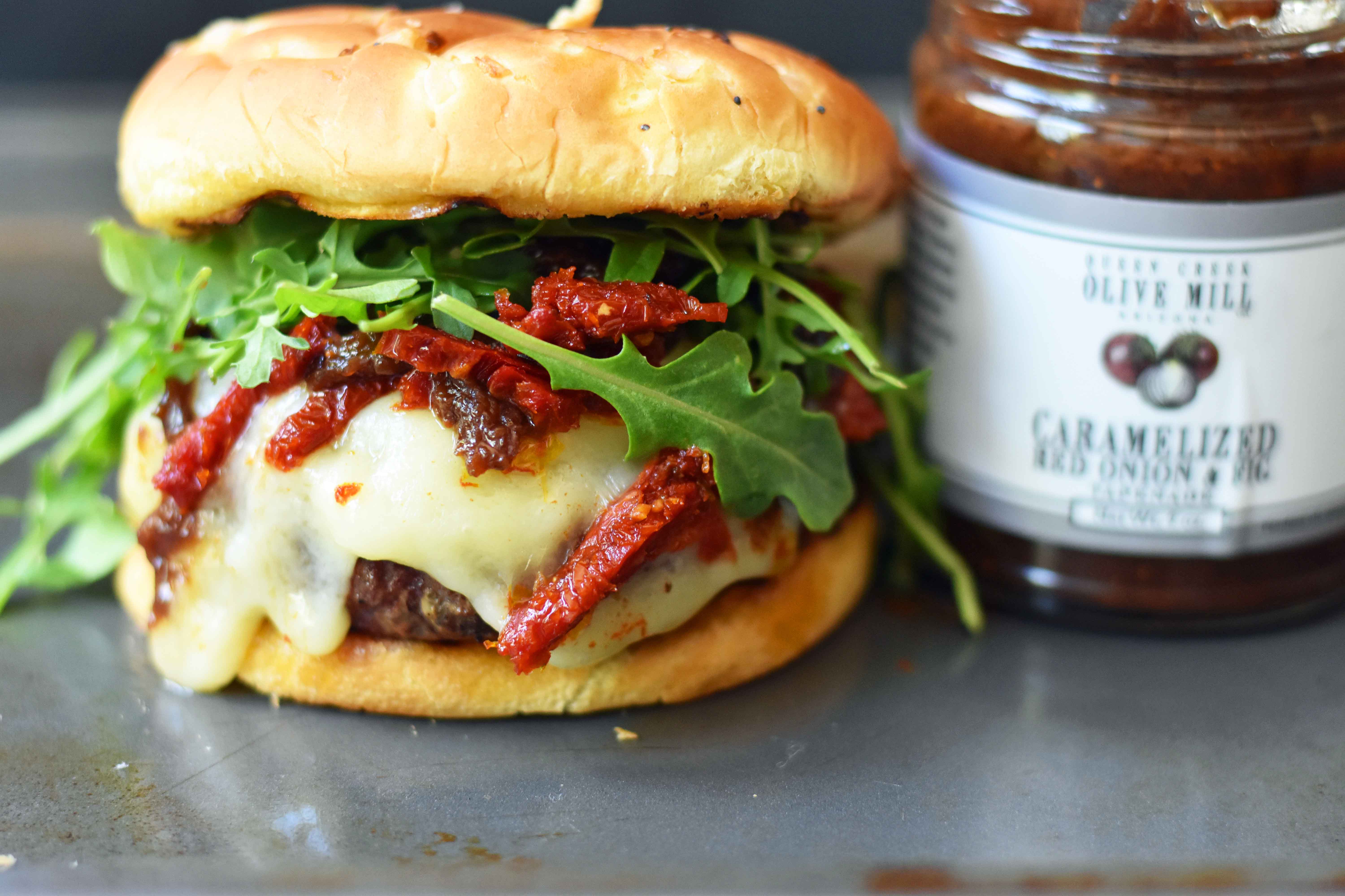 Brie Burger with Caramelized Onions and Sundried Tomatoes The Ultimate Burger with melted Brie Cheese, Sundried Tomatoes, Queen Creek Olive Mill Caramelized Red Onion Fig Tapenade, and Arugula. How to make the perfect burger. www.modernhoney.com