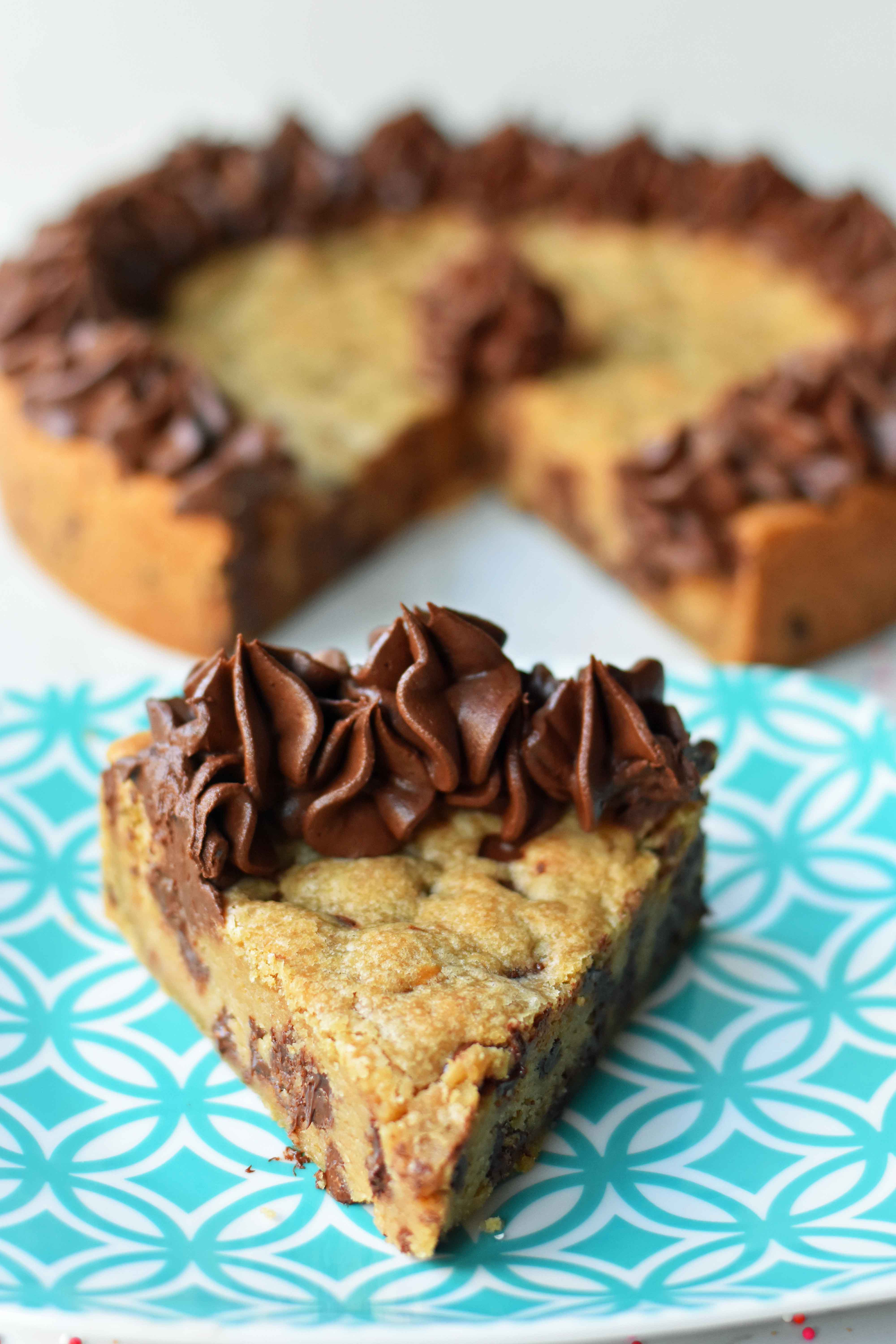 Chocolate Chip Cookie Cake. The BEST Homemade Cookie Cake. This Gigantic Frosted Chocolate Chip Cookie is perfect for birthdays or celebrations. A large decorated chocolate chip cookie recipe. www.modernhoney.com #cookie #cookies #largecookie #giganticcookie #frostedcookie #happybirthdaycookie #birthdaycookie #birthdaycookiecake #birthdaydesserts www.modernhoney.com