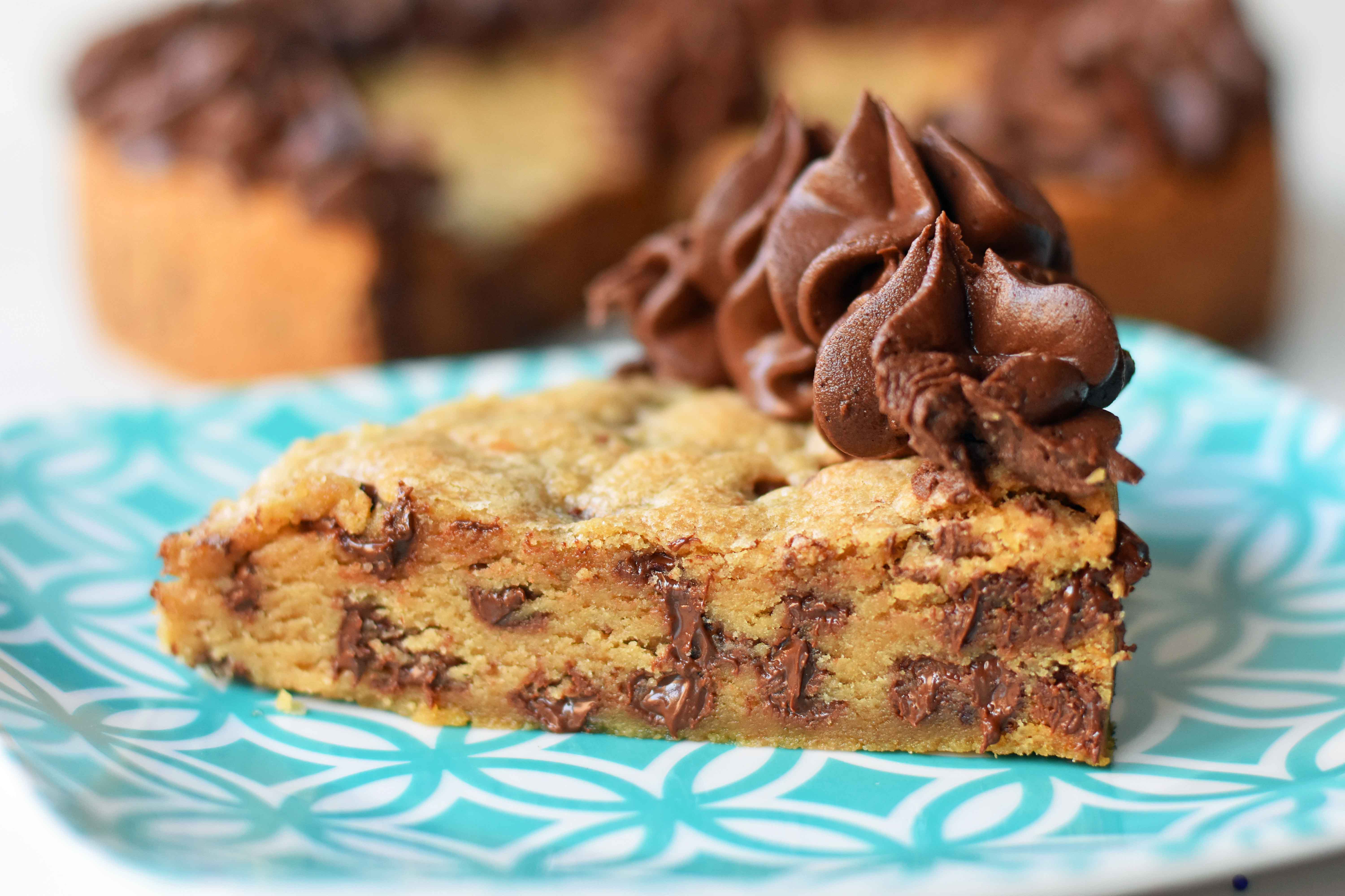 Chocolate Chip Cookie Cake. The BEST Homemade Cookie Cake. This Gigantic Frosted Chocolate Chip Cookie is perfect for birthdays or celebrations. A large decorated chocolate chip cookie recipe. www.modernhoney.com #cookie #cookies #largecookie #giganticcookie #frostedcookie #happybirthdaycookie #birthdaycookie #birthdaycookiecake #birthdaydesserts www.modernhoney.com