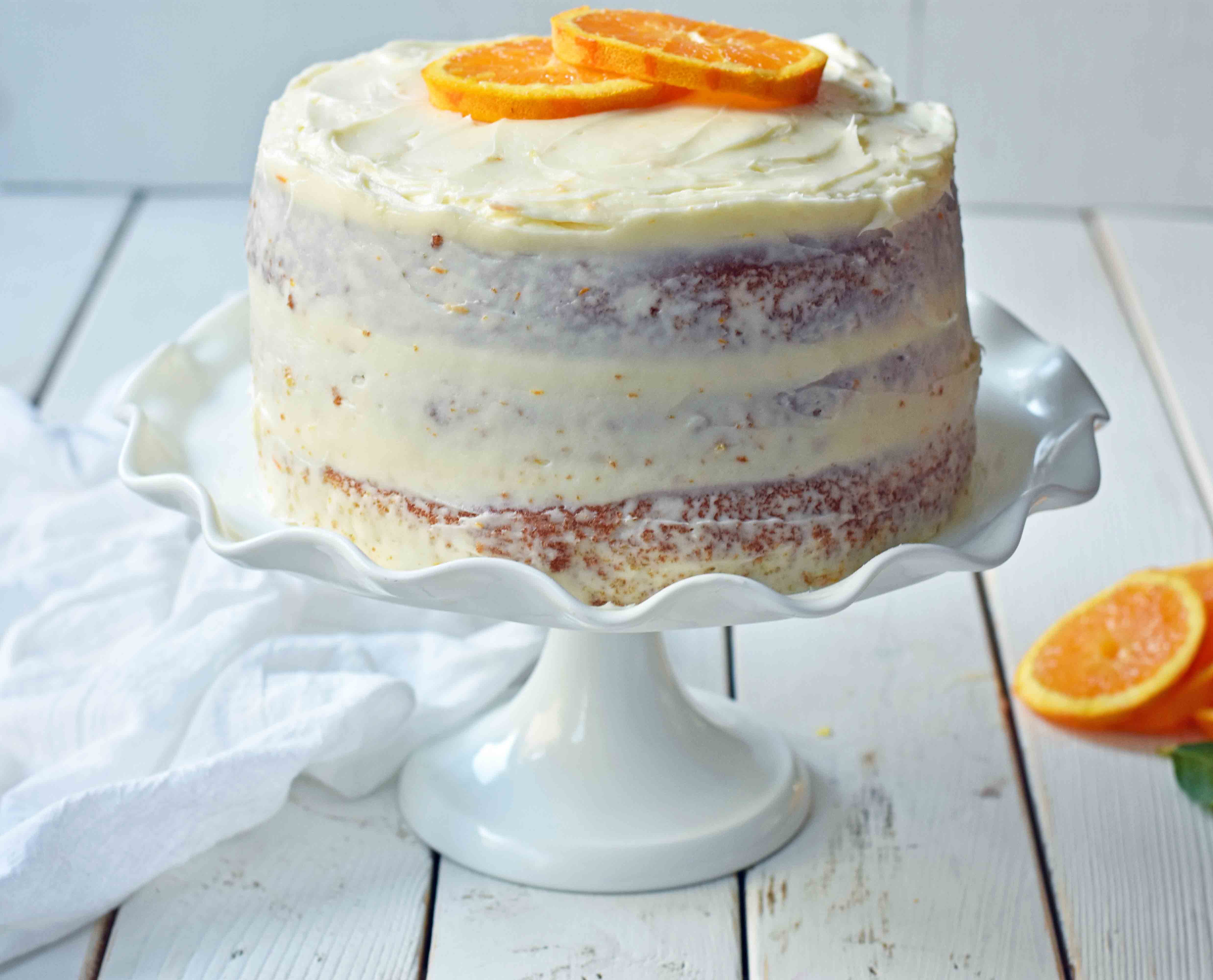 Homemade Orange Cake with Sweet Orange Cream Cheese Frosting. How to make the best orange cake. Orange cake with orange frosting. Naked orange cake. www.modernhoney.com #cake #orangecake #nakedcake #nakedorangecake