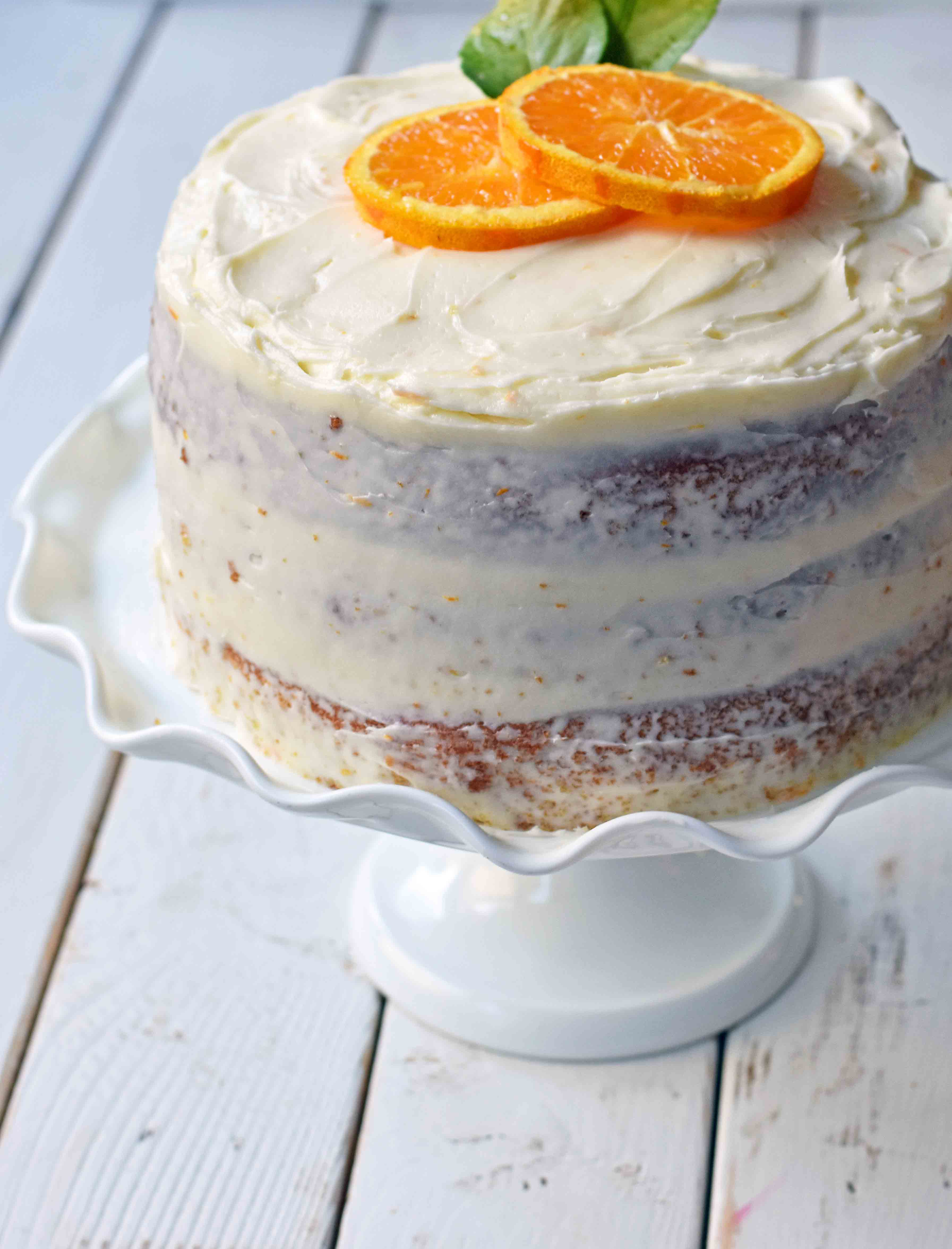 Homemade Orange Cake with Sweet Orange Cream Cheese Frosting. How to make the best orange cake. Orange cake with orange frosting. Naked orange cake. www.modernhoney.com #cake #orangecake #nakedcake #nakedorangecake