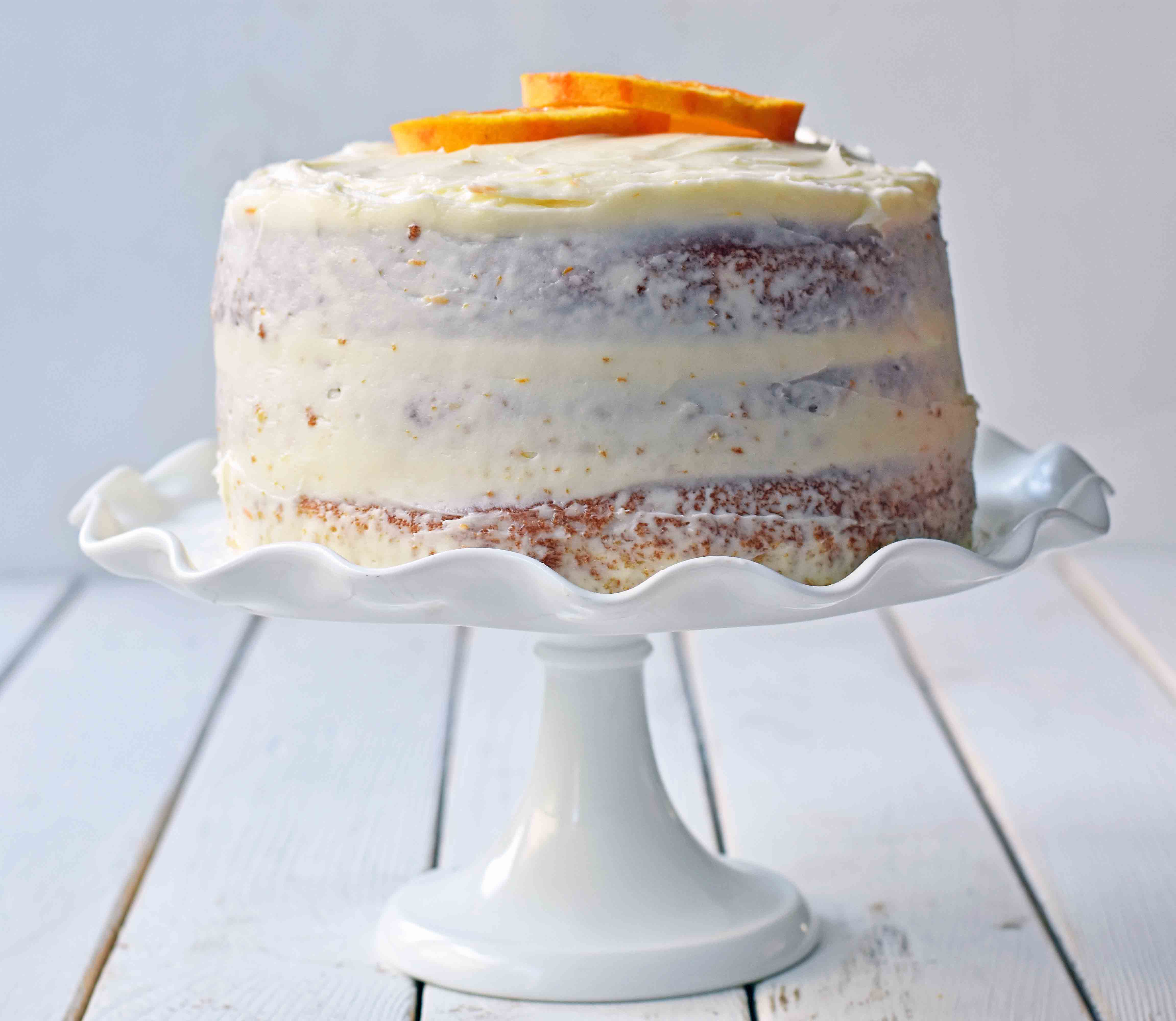 Homemade Orange Cake with Sweet Orange Cream Cheese Frosting. How to make the best orange cake. Orange cake with orange frosting. Naked orange cake. www.modernhoney.com #cake #orangecake #nakedcake #nakedorangecake