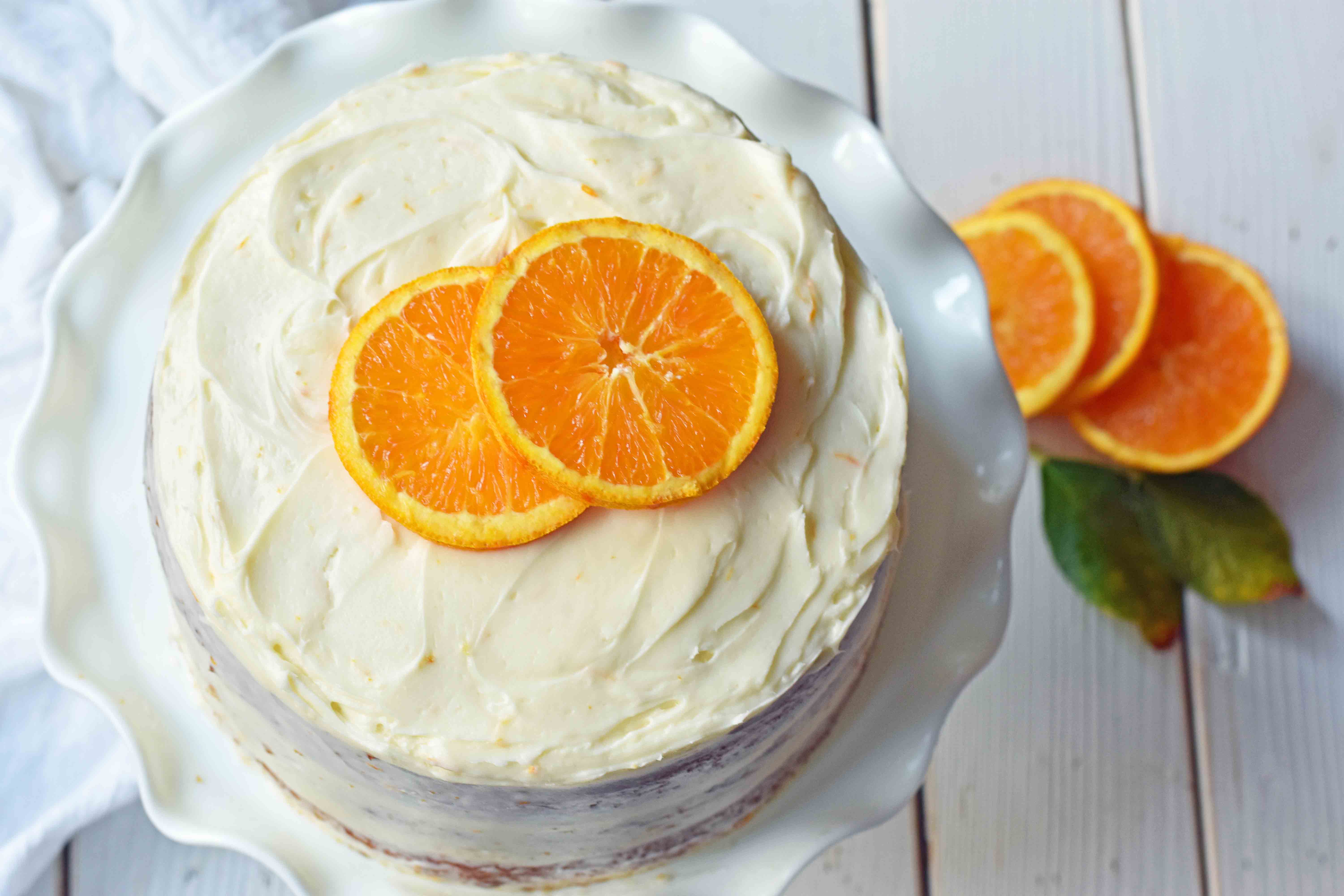 Homemade Orange Cake with Sweet Orange Cream Cheese Frosting. How to make the best orange cake. Orange cake with orange frosting. Naked orange cake. www.modernhoney.com #cake #orangecake #nakedcake #nakedorangecake