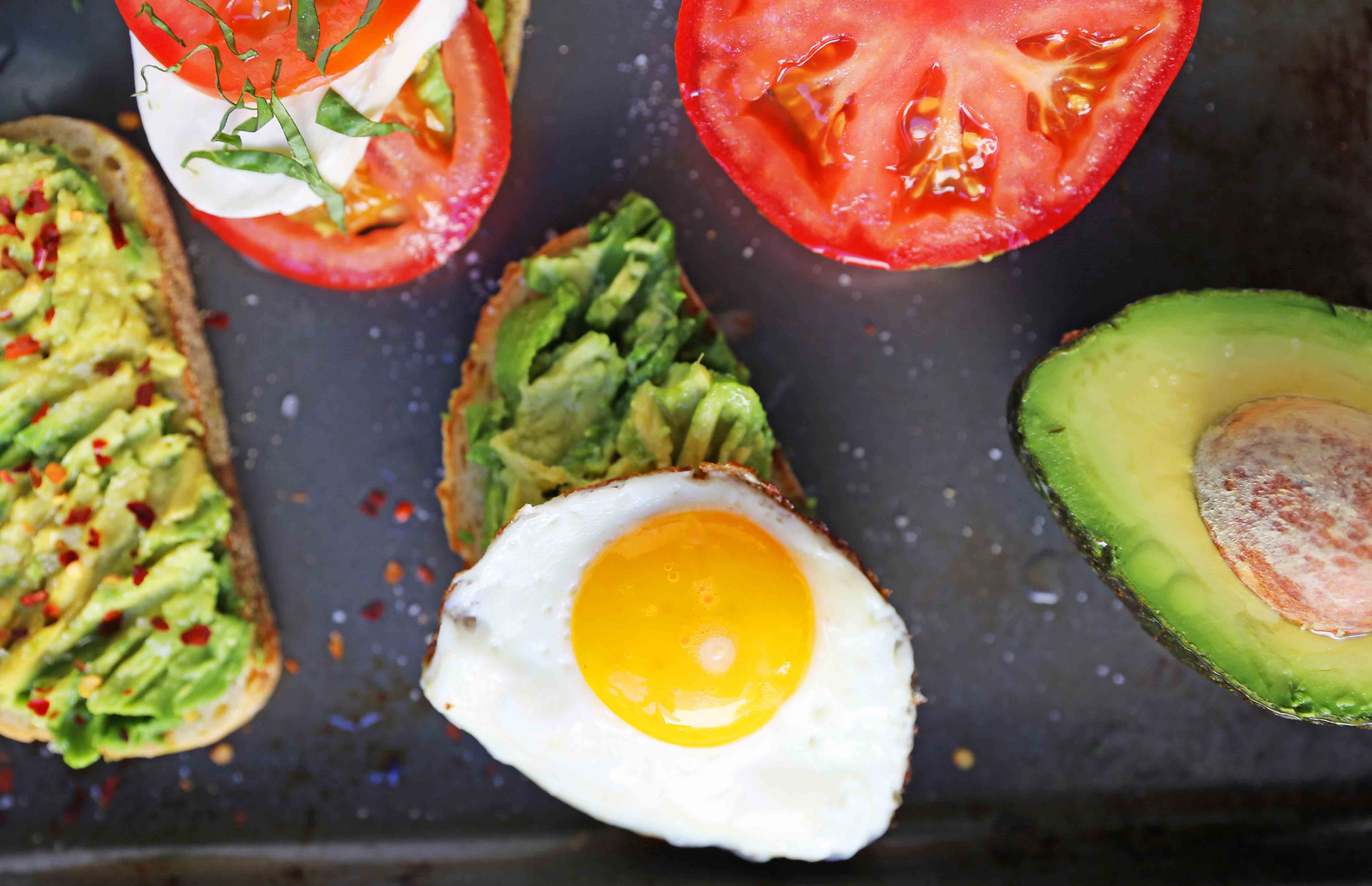 Avocado Toast -- 4 Ways. How to make perfect avocado toast. Caprese Avocado Toast, BAT Bacon Avocado Tomato Avocado Toast, Fried Egg Avocado Toast, Avocado Toast with Sea Salt and Chili Flakes. Tips and tricks for making the best avocado toast. www.modernhoney.com #avocadotoast #avocados #avocado