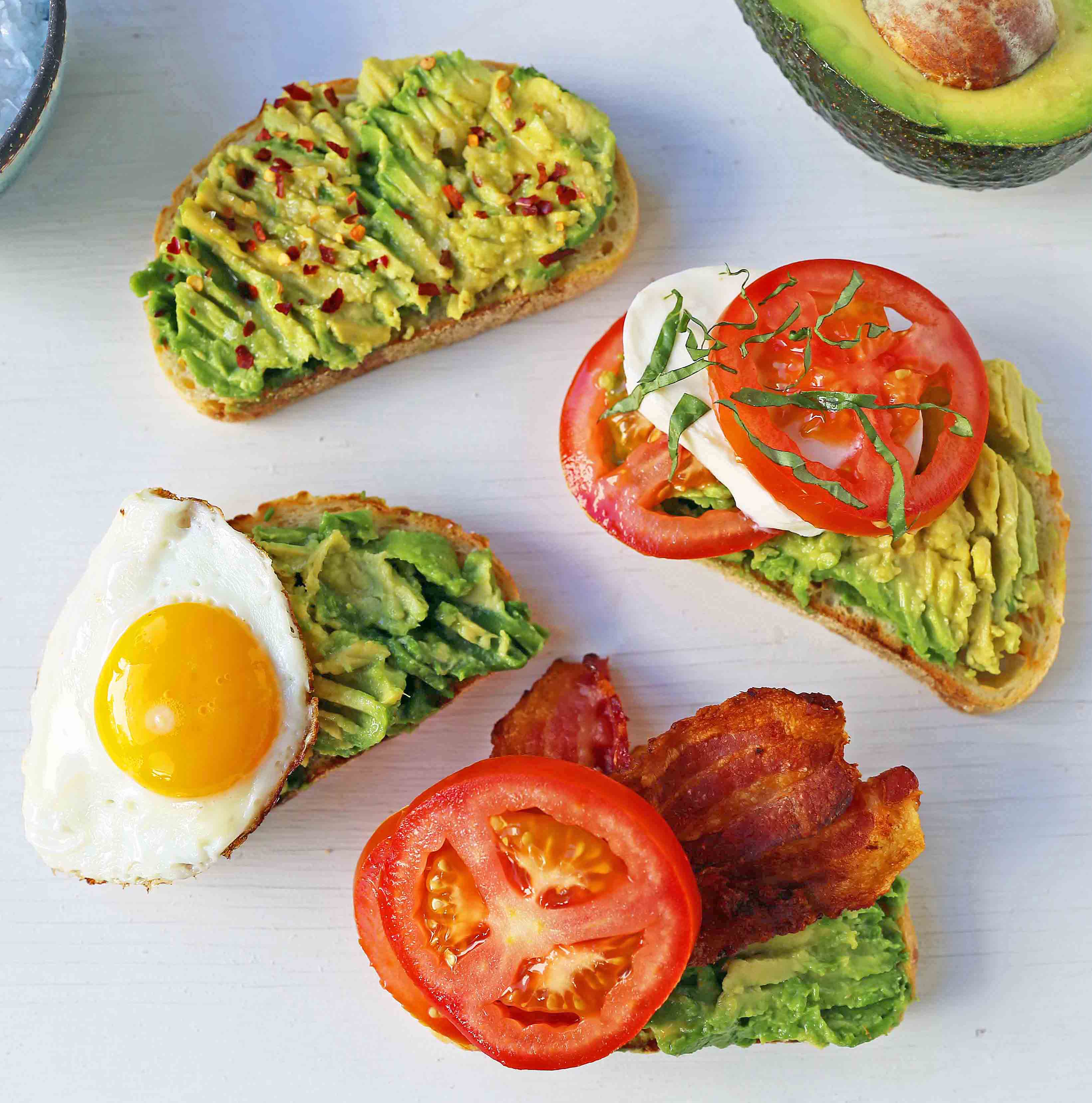 Avocado Toast -- 4 Ways. How to make perfect avocado toast. Caprese Avocado Toast, BAT Bacon Avocado Tomato Avocado Toast, Fried Egg Avocado Toast, Avocado Toast with Sea Salt and Chili Flakes. Tips and tricks for making the best avocado toast. www.modernhoney.com #avocadotoast #avocados #avocado 