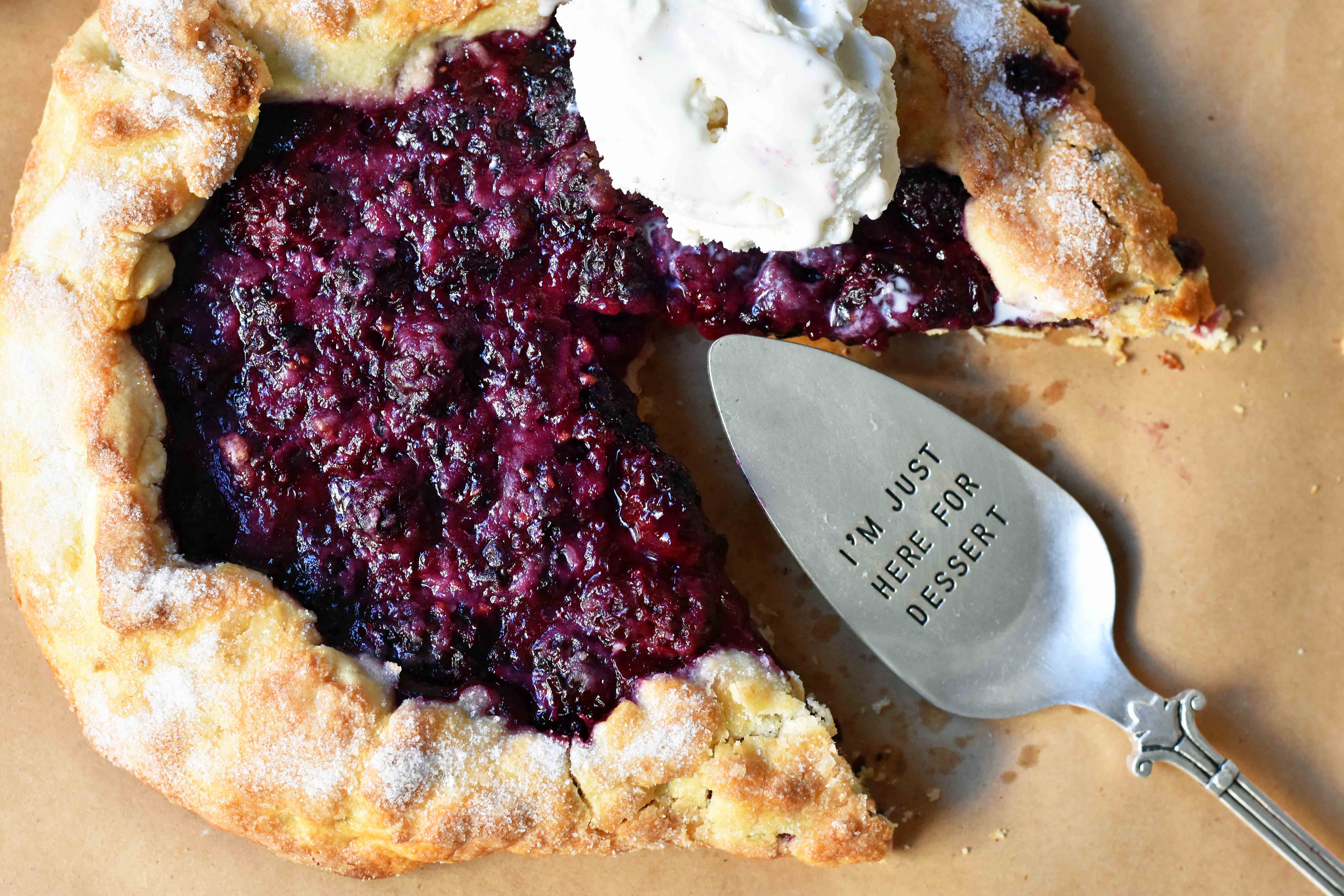 Blackberry Galette Crostata. An easy rustic summer dessert made with homemade buttery flaky pie crust with a sweet blackberry filling topped with vanilla bean ice cream. A much easier blackberry pie! www.modernhoney.com #galette #crostata #blackberrycrostata #blackberrygalette #summerdessert #berrydessert