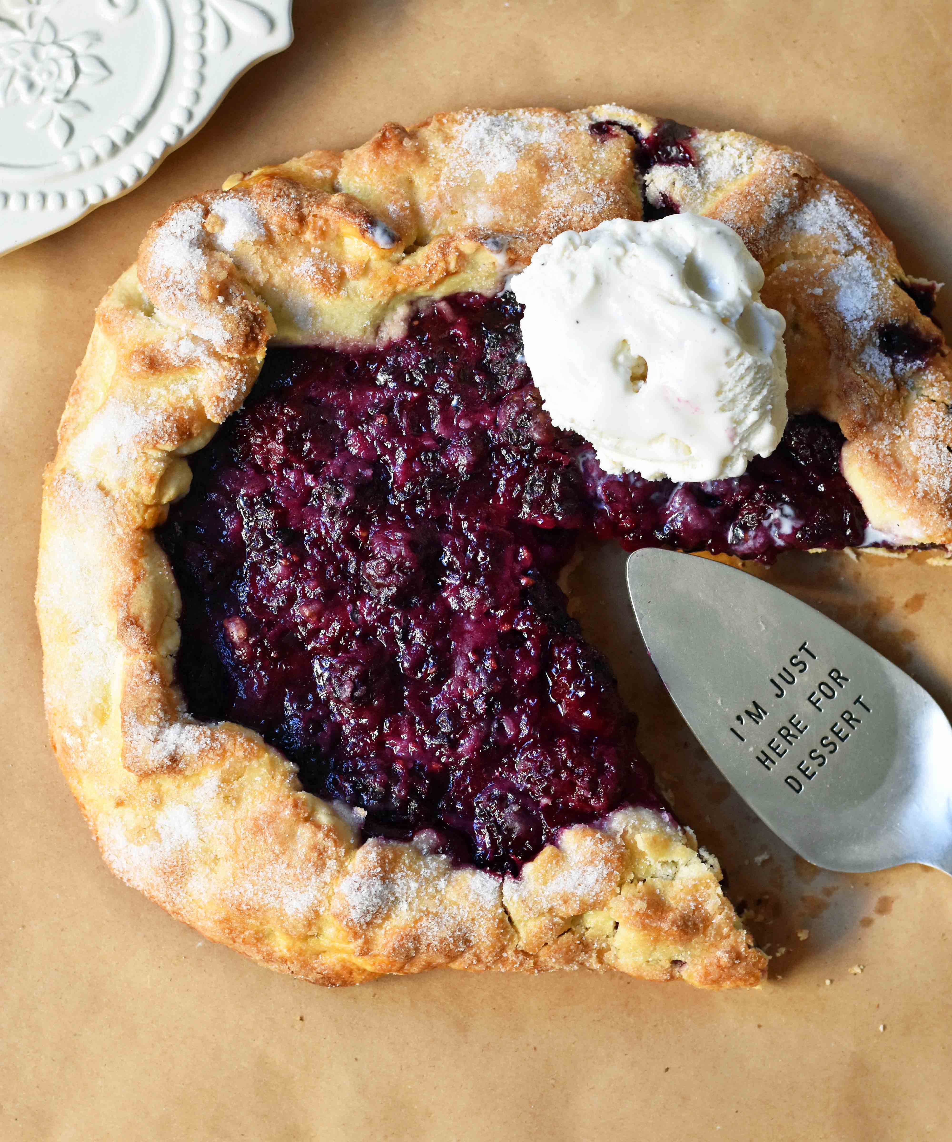 Blackberry Galette Crostata. An easy rustic summer dessert made with homemade buttery flaky pie crust with a sweet blackberry filling topped with vanilla bean ice cream. A much easier blackberry pie! www.modernhoney.com #galette #crostata #blackberrycrostata #blackberrygalette #summerdessert #berrydessert