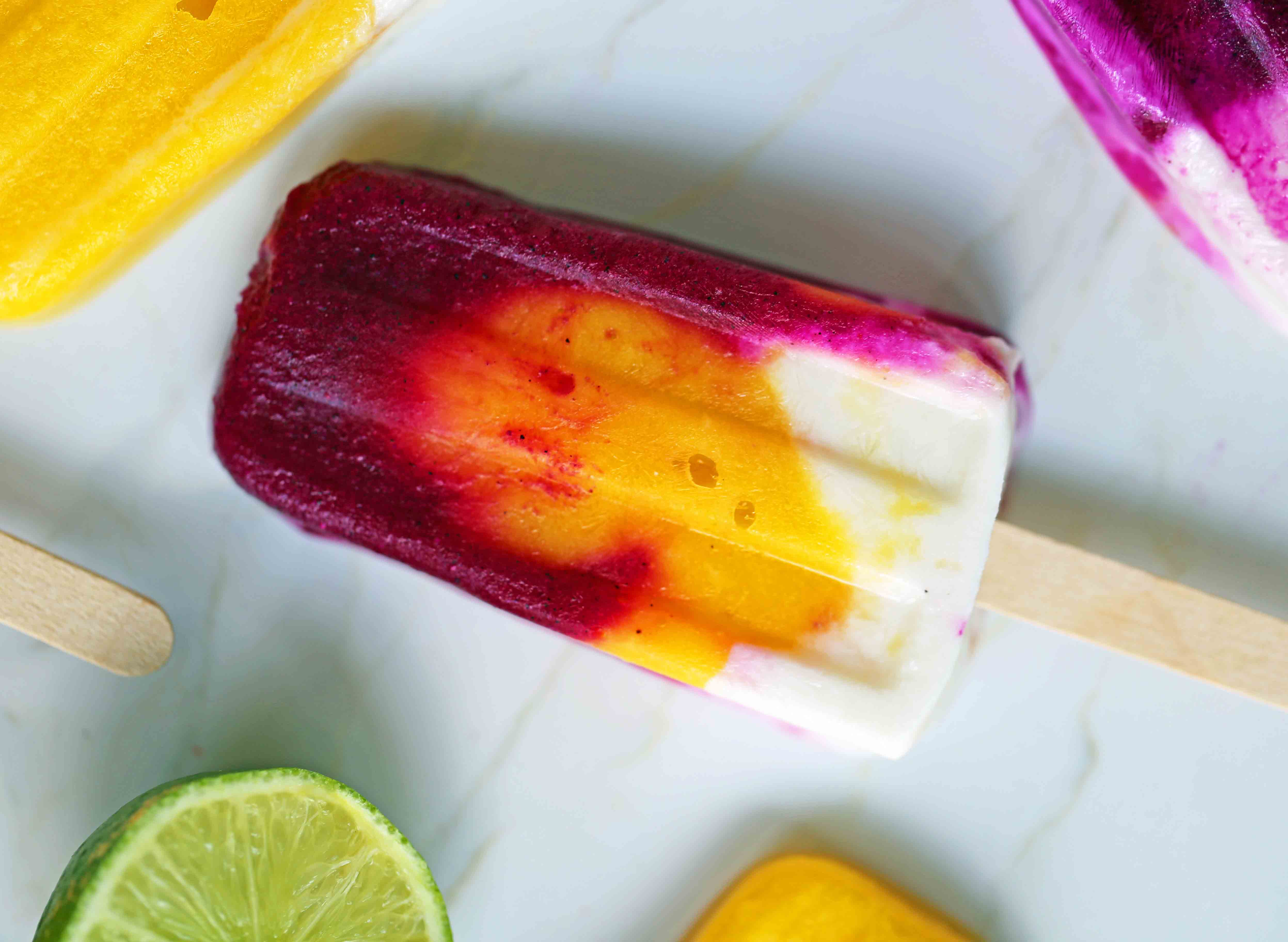 Homemade Fruit Popsicles Recipe. Fruit and Cream Popsicles. How to make homemade fruit and cream popsicles. Mango and Cream Popsicles. Pitaya and Cream Popsicles. Peaches and Cream Popsicles. Pitaya Strawberry Popsicles. www.modernhoney.com #popsicles #fruitpopsicles #fruitandcreampopsicles #homemadepopsicles