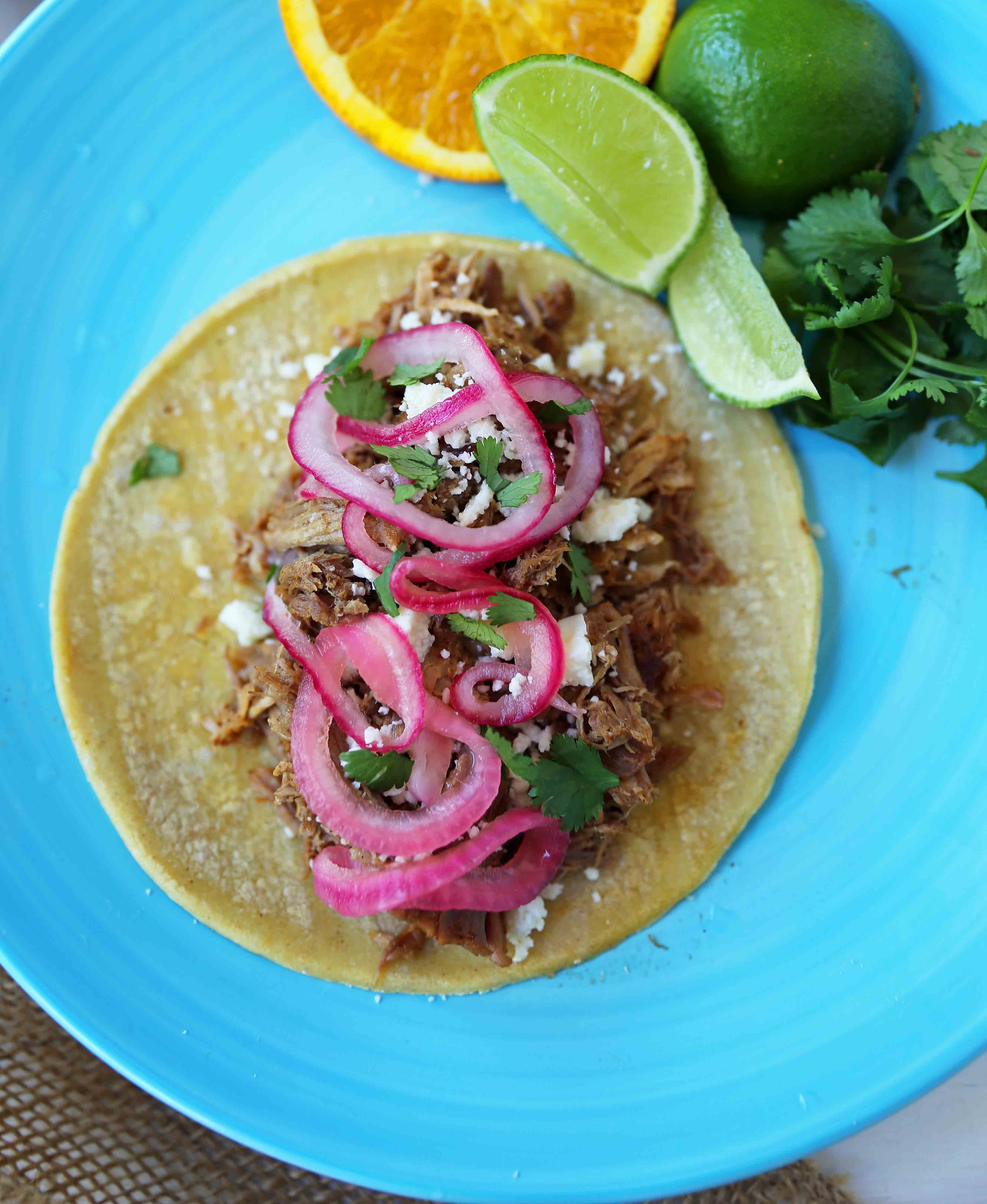 Mexican Pork Carnitas Tacos. Slow Cooker Pork Carnitas with Pickled Onions. How to make tender and flavorful pork carnitas slow cooked in Coca-Cola and citrus juices. www.modernhoney.com #tacos #carnitas #porkcarnitas #slowcooker #slowcookercarnitas