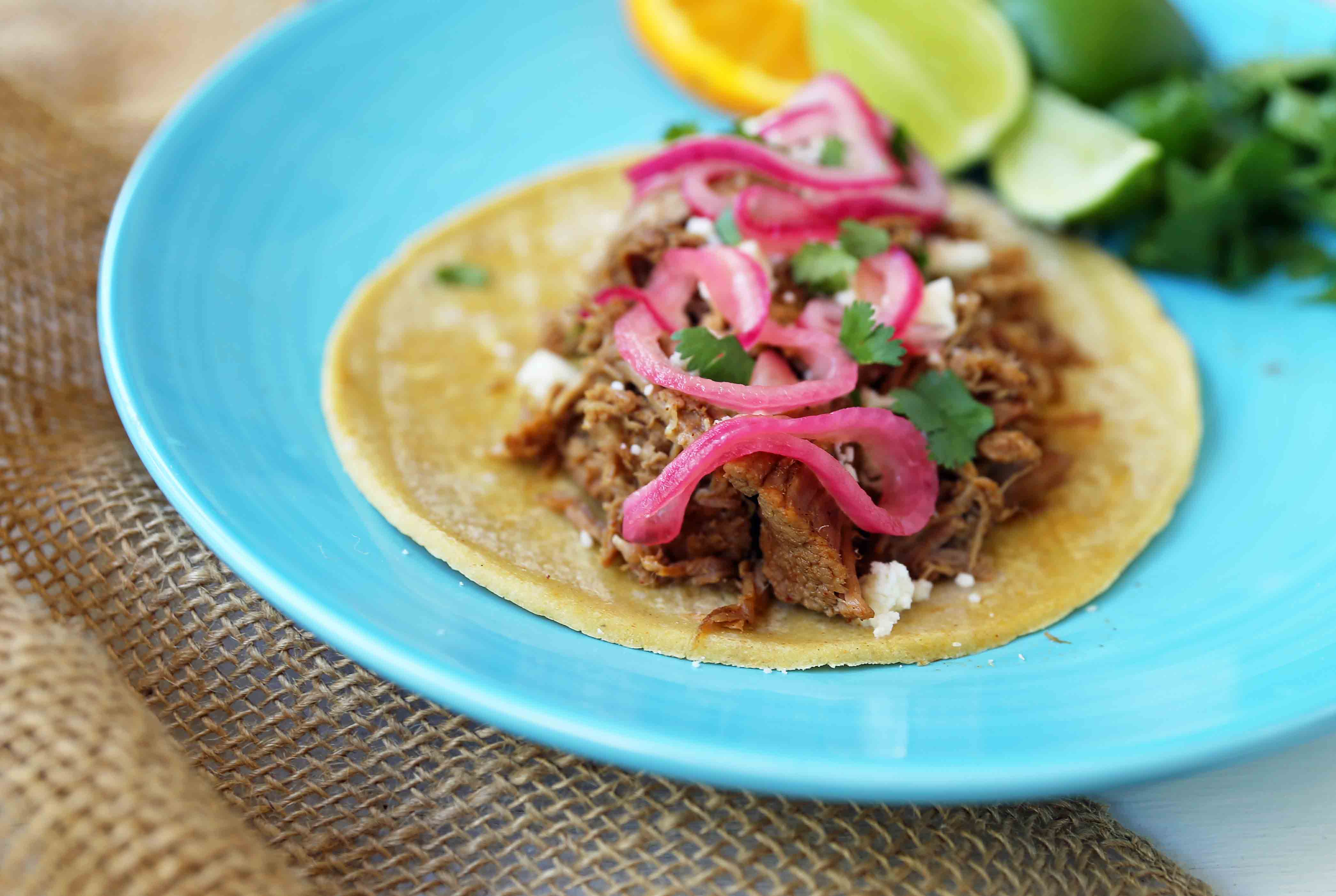 Mexican Pork Carnitas Tacos. Slow Cooker Pork Carnitas with Pickled Onions. How to make tender and flavorful pork carnitas slow cooked in Coca-Cola and citrus juices. www.modernhoney.com #tacos #carnitas #porkcarnitas #slowcooker #slowcookercarnitas