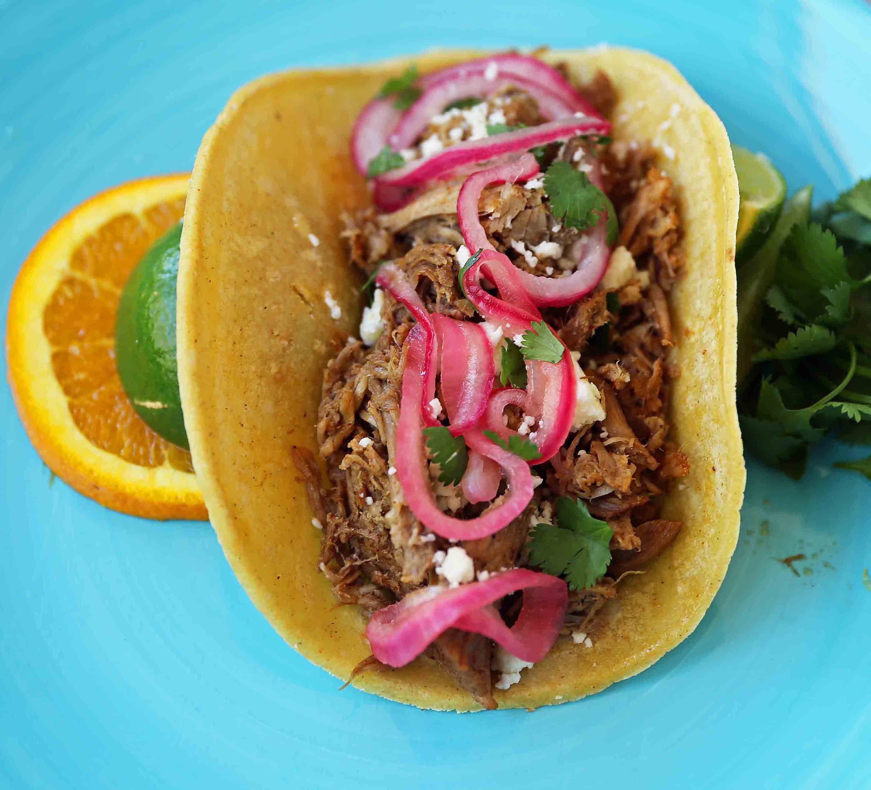 Mexican Pork Carnitas Tacos. Slow Cooker Pork Carnitas with Pickled Onions. How to make tender and flavorful pork carnitas slow cooked in Coca-Cola and citrus juices. www.modernhoney.com #tacos #carnitas #porkcarnitas #slowcooker #slowcookercarnitas