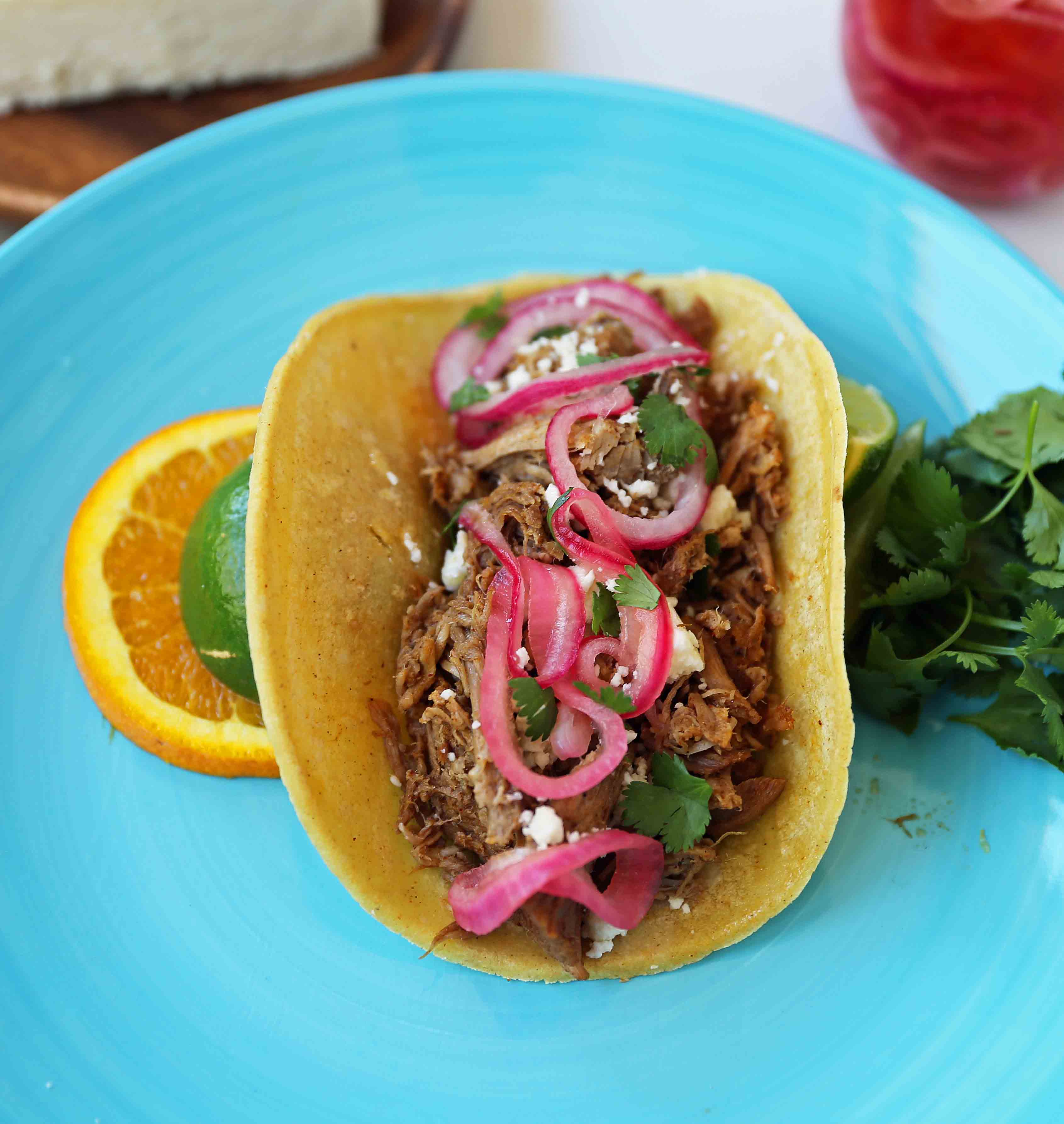 Mexican Pork Carnitas Tacos. Slow Cooker Pork Carnitas with Pickled Onions. How to make tender and flavorful pork carnitas slow cooked in Coca-Cola and citrus juices. www.modernhoney.com #tacos #carnitas #porkcarnitas #slowcooker #slowcookercarnitas