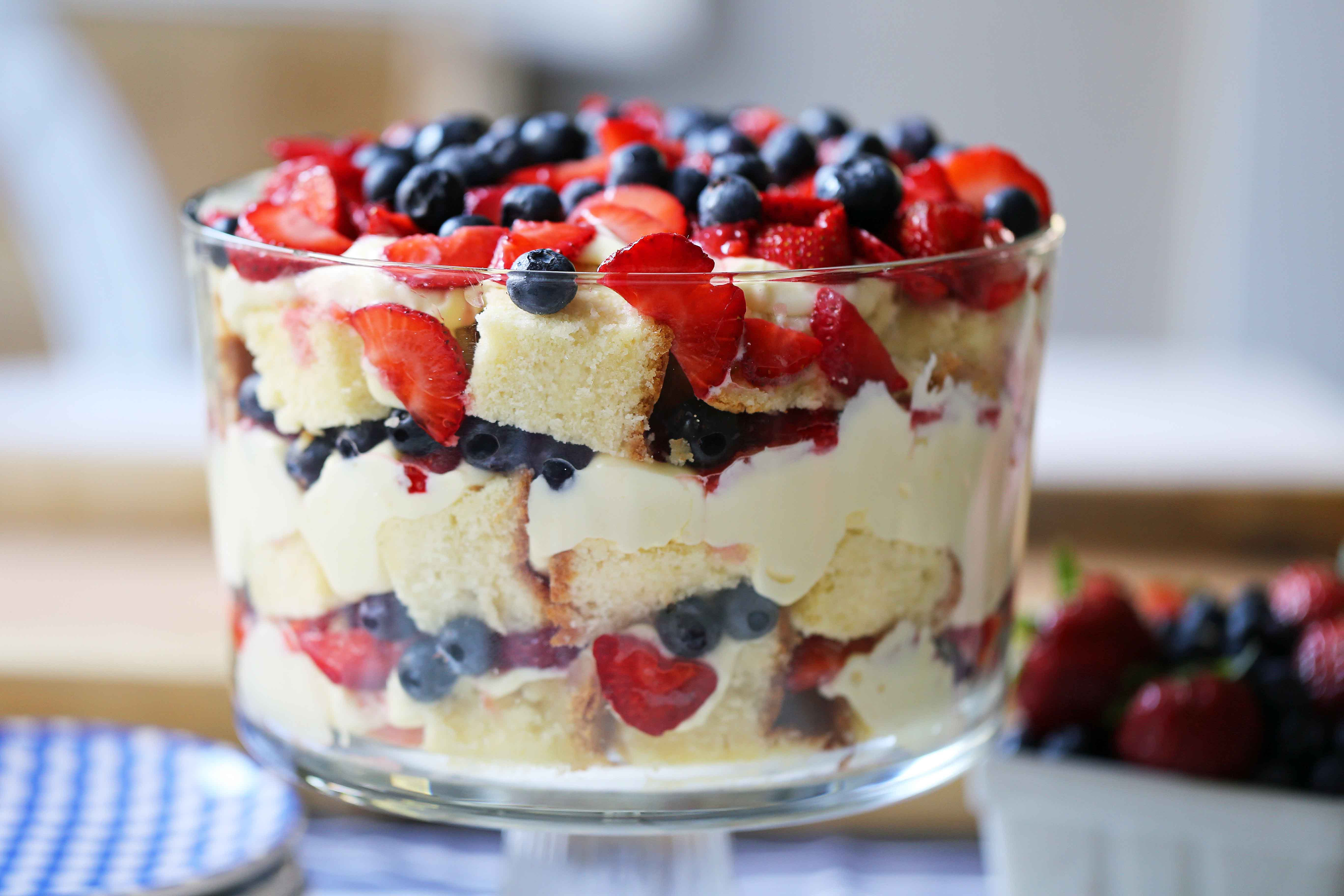 Summer Berry Trifle made with homemade cream cheese pound cake, creamy custard filling, and sweet fruit. A gorgeous summer dessert! Perfect dessert for a potluck and party. Patriotic 4th of July dessert. www.modernhoney.com #trifle #4thofJuly #patrioticdessert #trifle