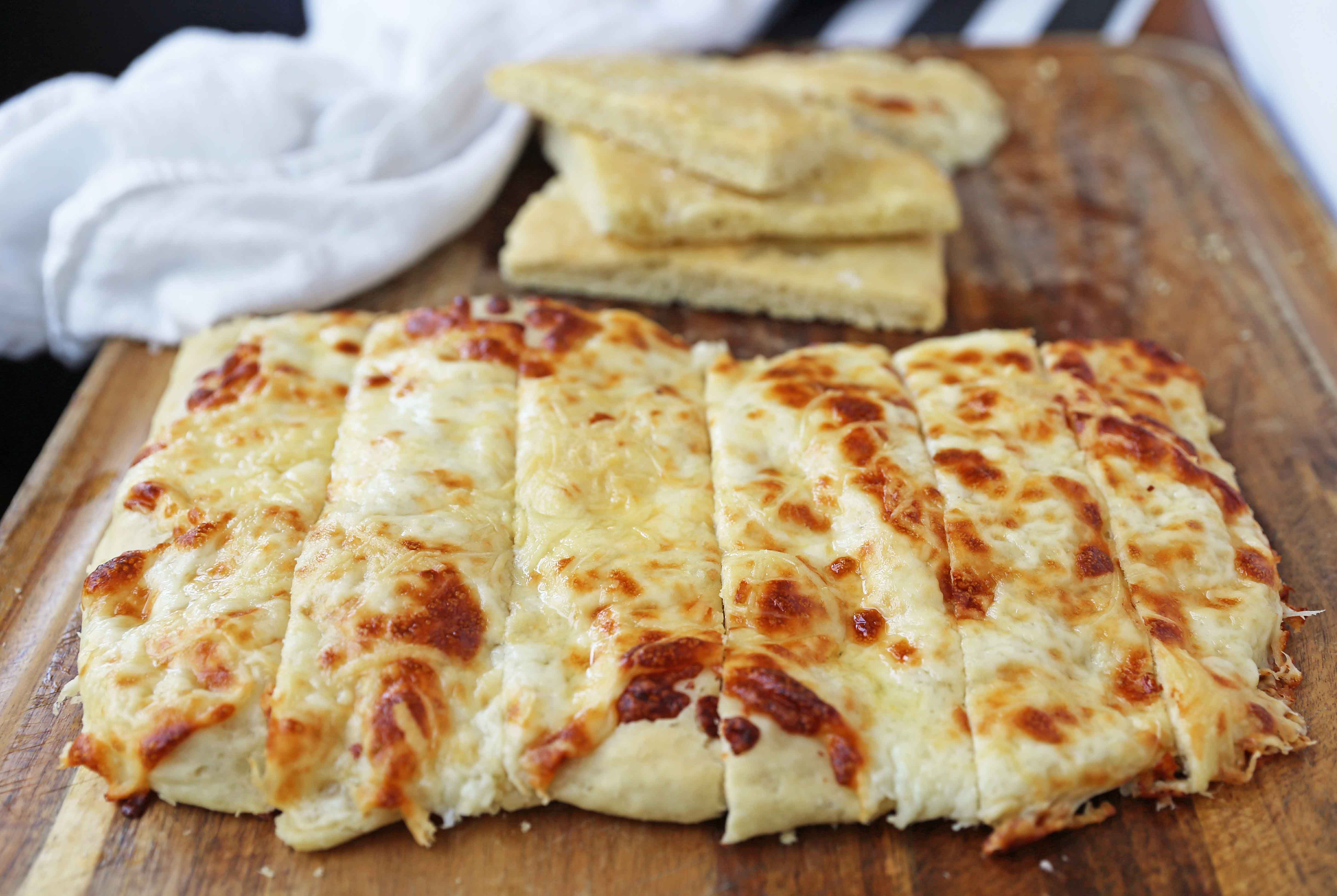 Cheese Focaccia Bread Recipe. How to make garlic cheese focaccia bread from scratch. The best garlic cheese breadsticks. www.moderhoney.com #focaccia