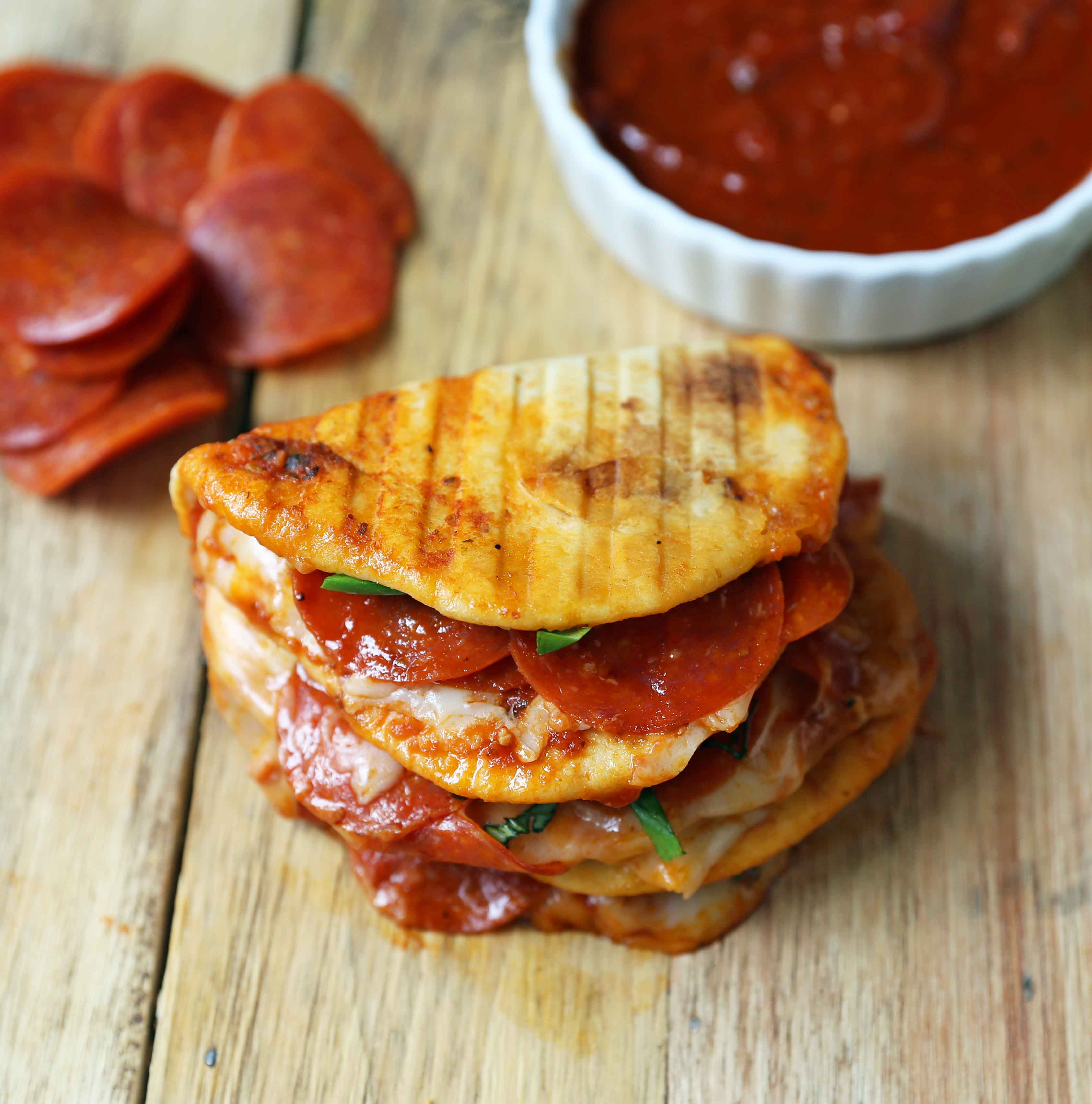 Pepperoni Pizza Flatbread Pizza. Soft chewy naan bread topped with marinara sauce, mozzarella cheese, and pepperonis. Pepperoni and Cheese Panini baked until toasty and golden brown. www.modernhoney.com #panini #pepperoni #pizza #pizzapanini