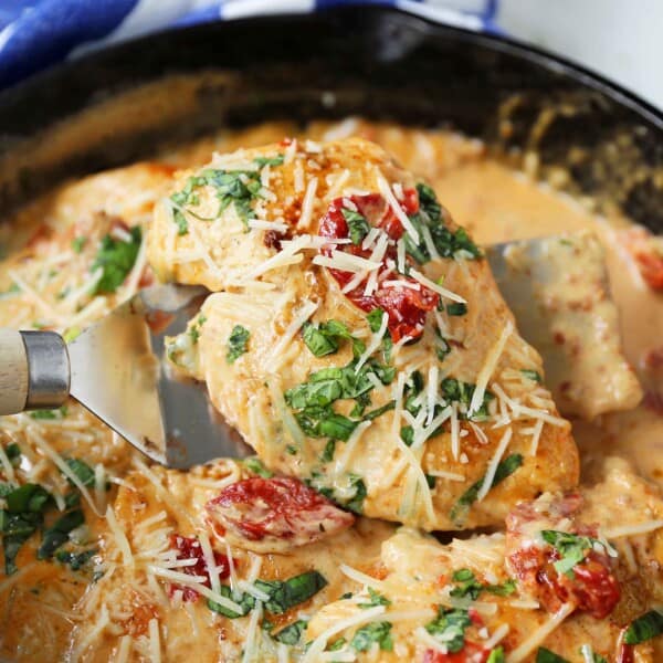 Skillet Chicken with Sun-Dried Tomato Cream Sauce. 20-Minute Chicken made with garlic butter sun-dried tomato parmesan cheese cream sauce. The most flavorful chicken and sauce! You will want to drink the sauce...its THAT GOOD! www.modernhoney.com