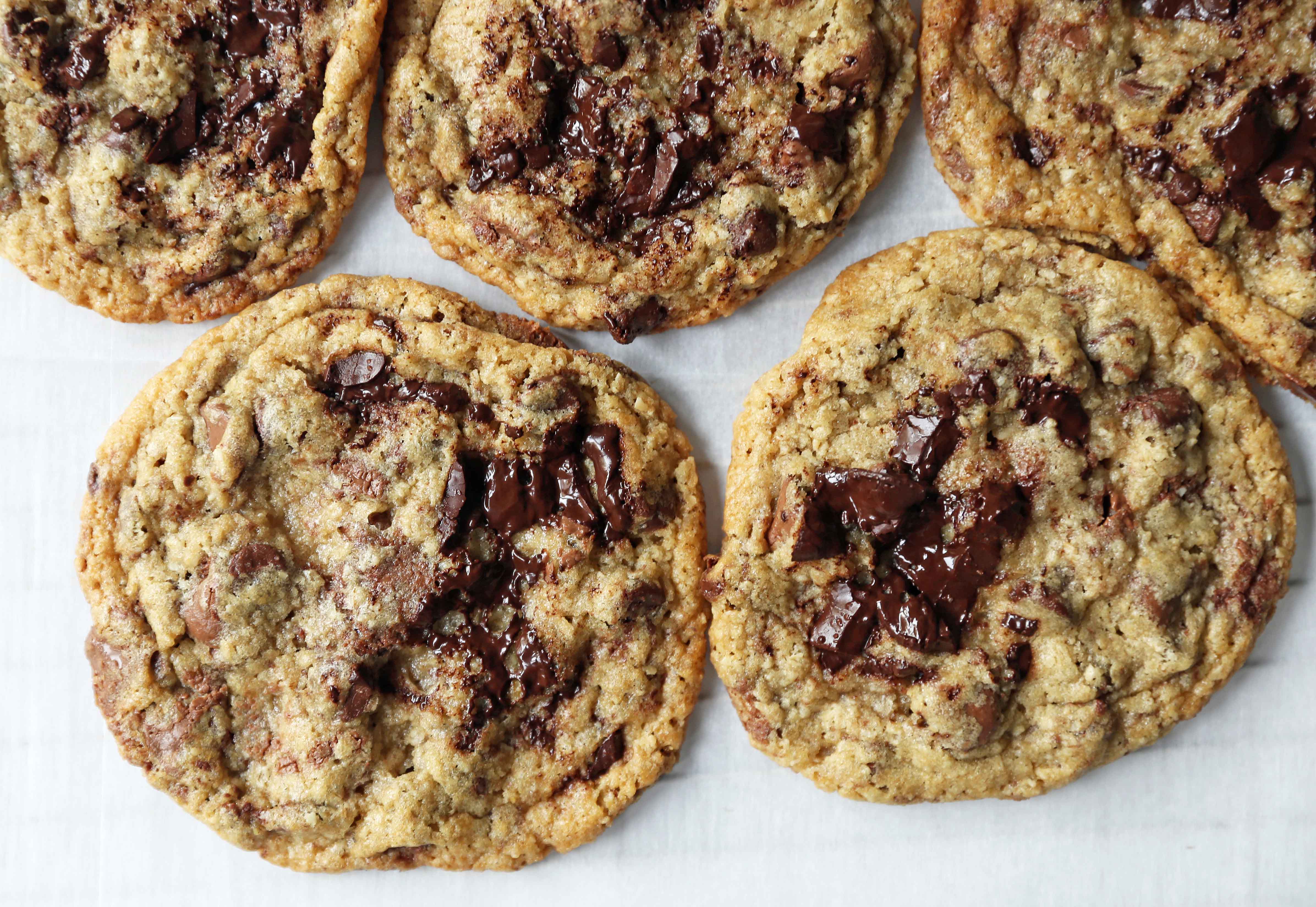 Chocolate Chip Oatmeal Cookies Recipe. Chocolate chip cookies with ground oatmeal have the perfect chewy, crispy texture. This NYC Milk and Cookies Bakery Copycat Cookie Recipe will become a favorite in no time at all! www.modernhoney.com #chocolatechipcookies #chocolatechipoatmealcookies