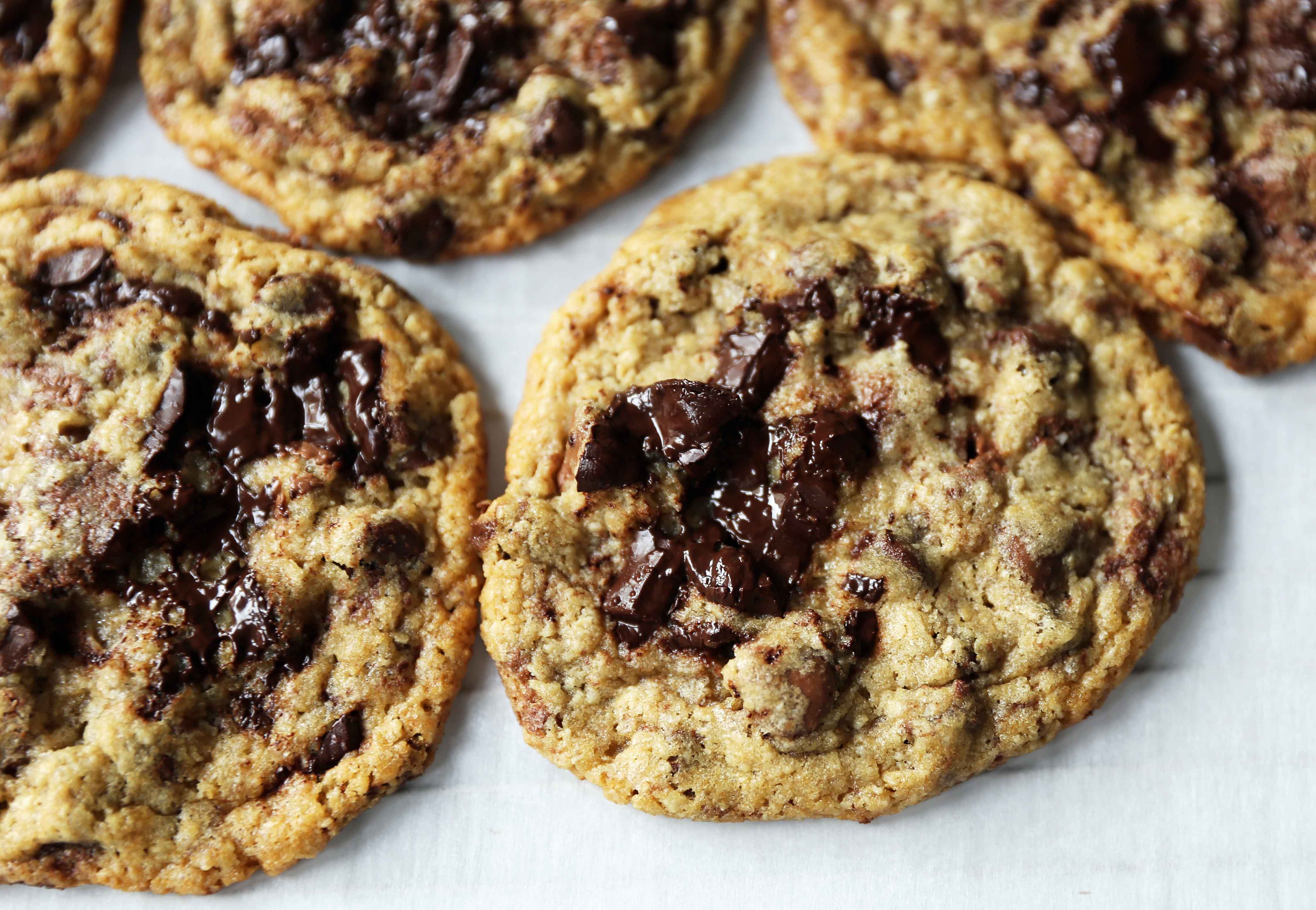 Chocolate Chip Oatmeal Cookies Recipe. Chocolate chip cookies with ground oatmeal have the perfect chewy, crispy texture. This NYC Milk and Cookies Bakery Copycat Cookie Recipe will become a favorite in no time at all! www.modernhoney.com #chocolatechipcookies #chocolatechipoatmealcookies