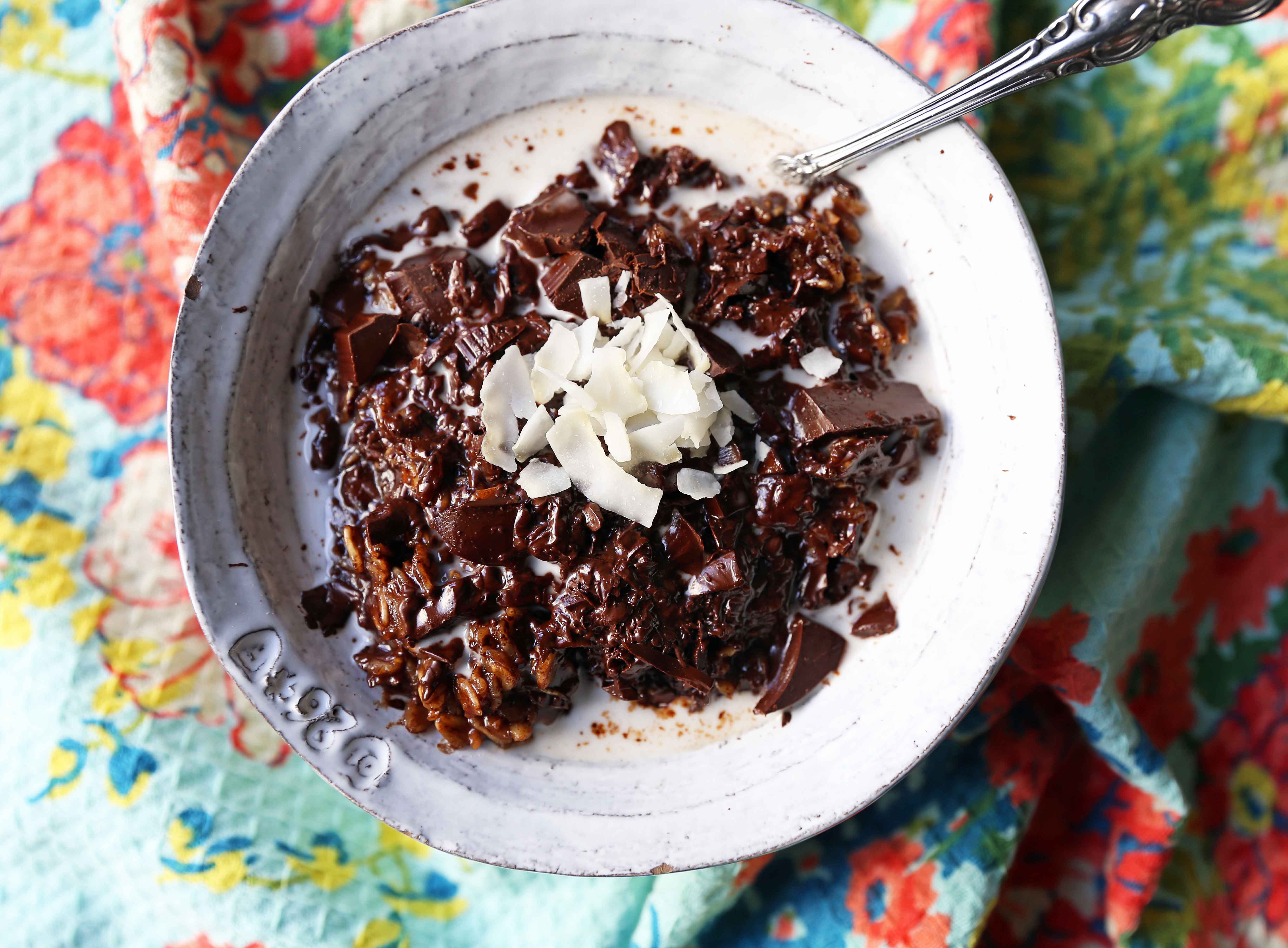 Decadent double chocolate oatmeal with coconut flakes is made with rolled oats mixed with creamy coconut milk, cocoa, lightly sweetened, and topped with chocolate chunks. These creamy chocolate oats are a rich, heavenly breakfast!