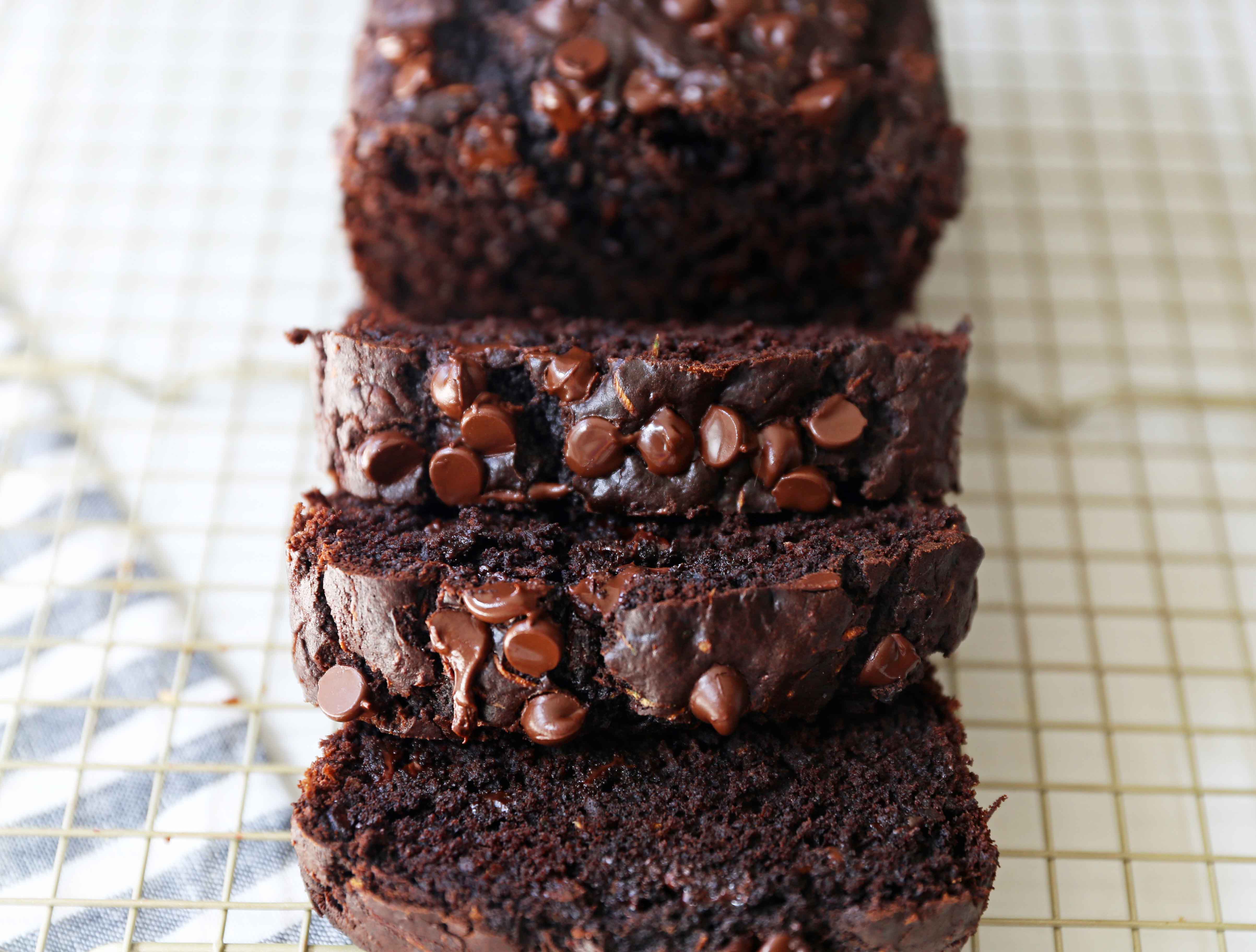 Chocolate Zucchini Bread. A rich double chocolate zucchini bread with chocolate chips recipe. You will never know there is zucchini in this chocolate bread! It is moist, rich, and a chocolate lover's dream! www.modernhoney.com #zucchinibread #chocolatezucchinibread #zucchinirecipes