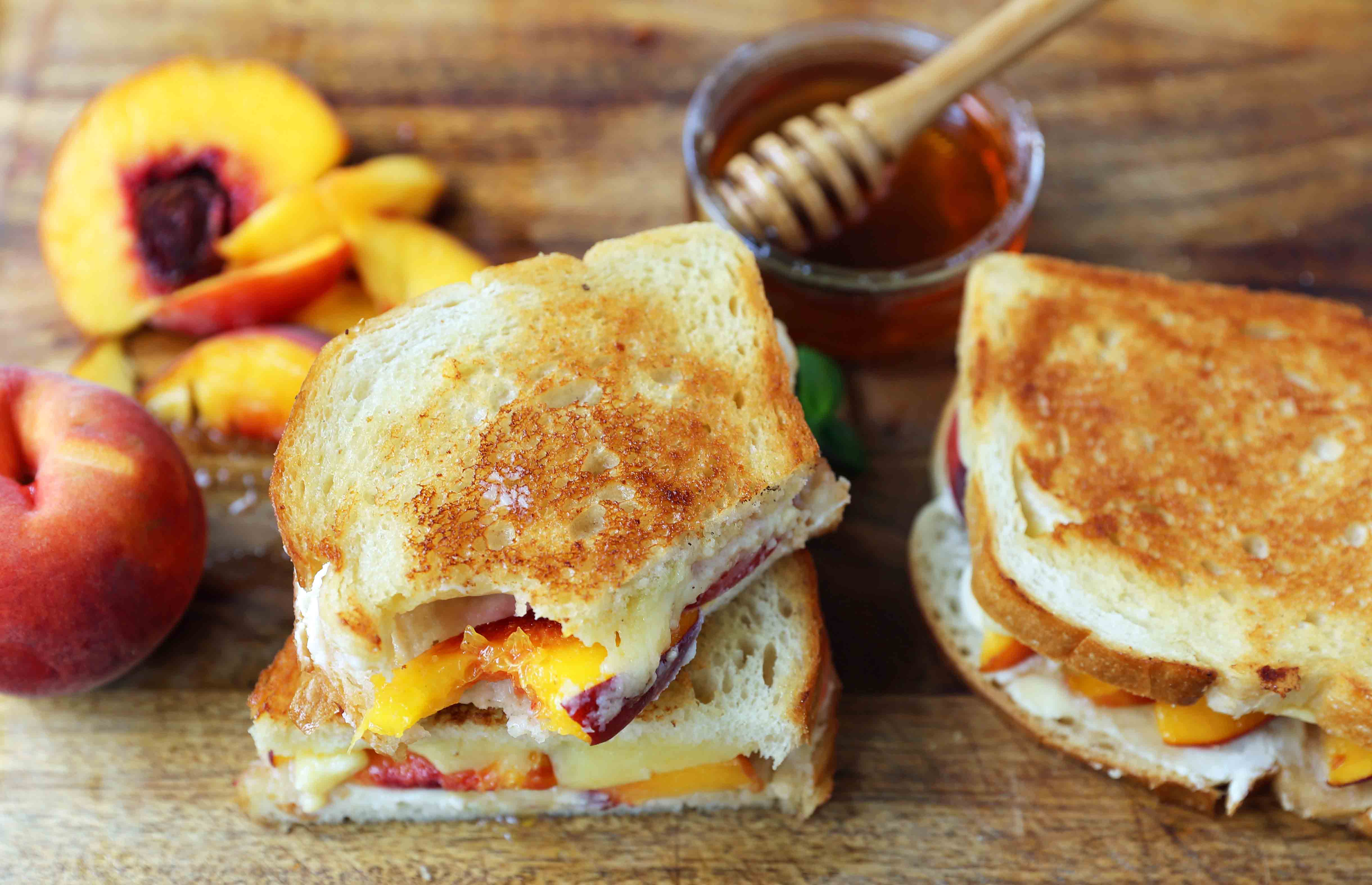 Honey Peach White Cheddar Grilled Cheese Sandwich. A summer grilled cheese sandwich with sweet juicy peaches, white cheddar cheese, a drizzle of honey on buttery toasted bread. www.modernhoney.com #peaches #grilledcheese #peachgrilledcheese 