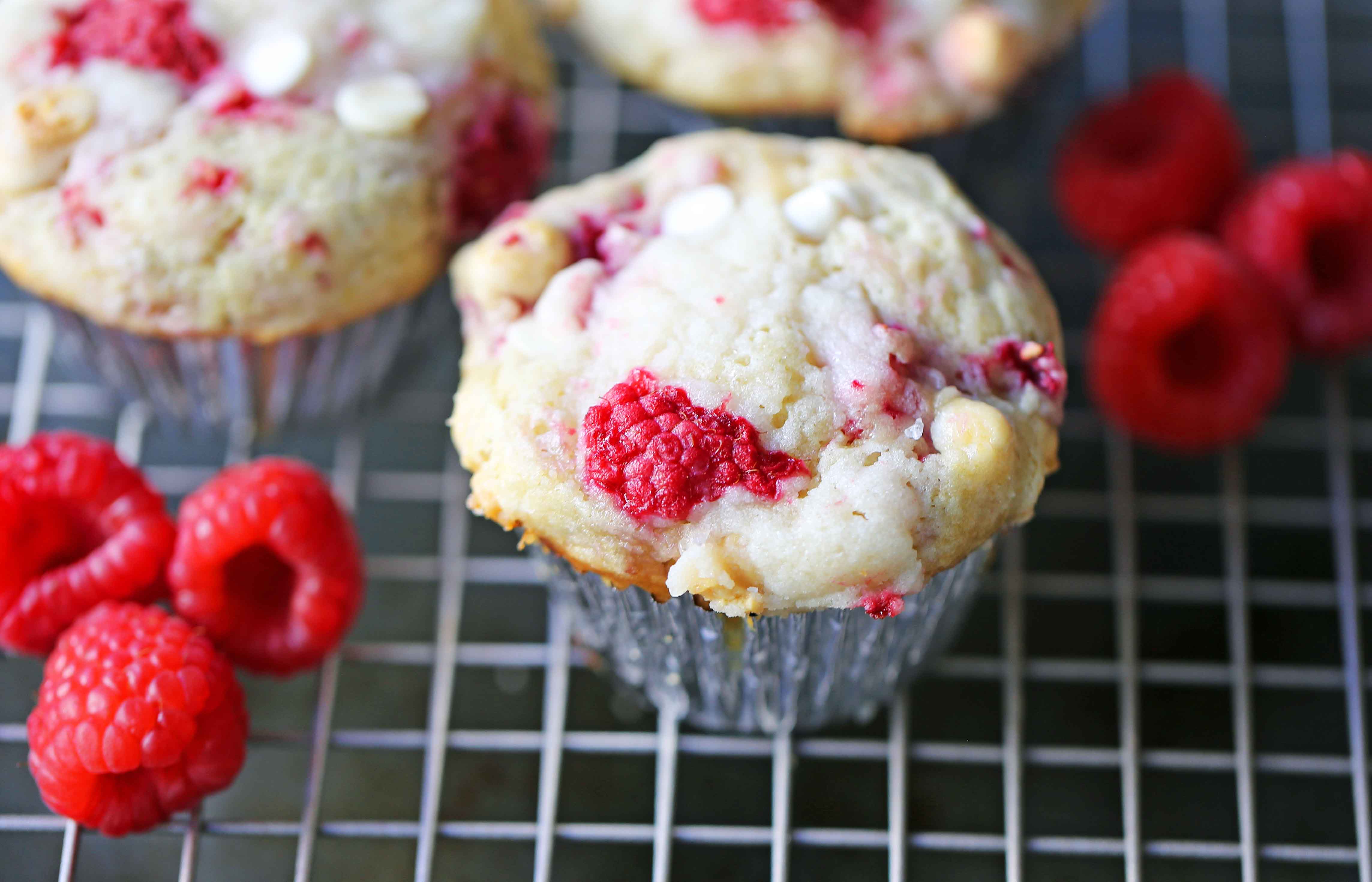 Raspberry White Chocolate Muffins. Soft, moist muffins with fresh raspberries and sweet white chocolate chips. The perfect tart and sweet muffin recipe. Moist raspberry muffins recipe. www.modernhoney.com #raspberrymuffins #muffins #muffinsrecipe