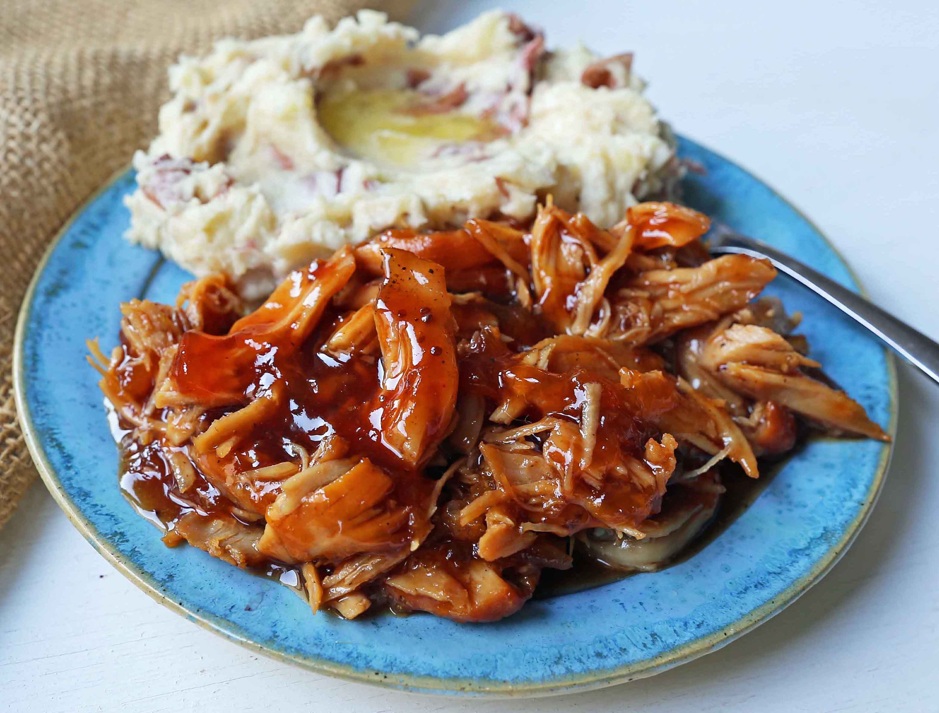 Slow Cooker Peach Barbecue Sauce Chicken. 5-Ingredient Crockpot Chicken with Sweet Peach BBQ Glaze. A fast and flavorful slow cooker chicken with peach bbq sauce. www.modernhoney.com #slowcooker #crockpot