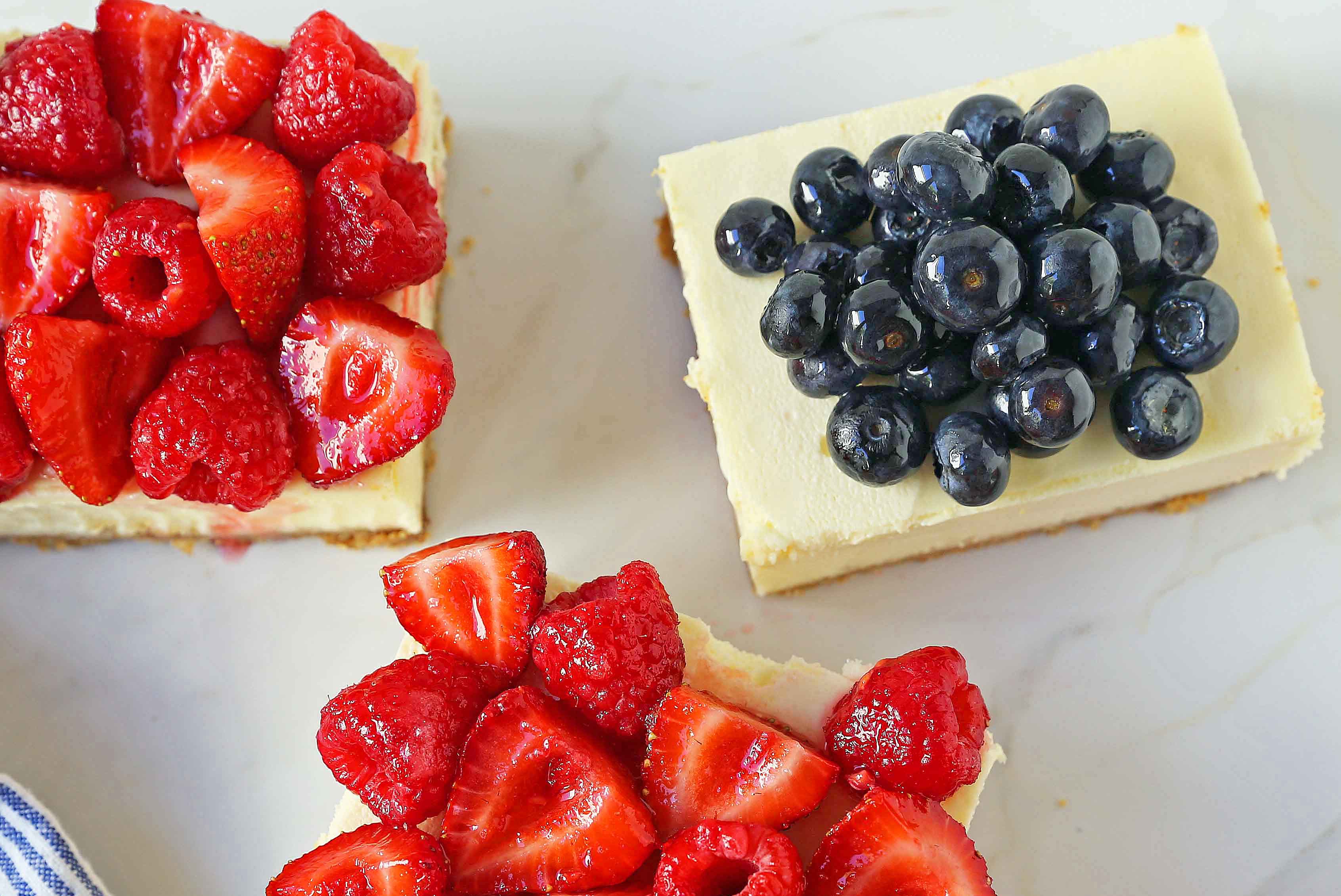 Cheesecake Bars with Driscoll's Berries. Creamy cheesecake bars with buttery graham cracker crust. The perfect cheesecake square! www.modernhoney.com #cheesecake #cheesecakebars #cheesecakesquares