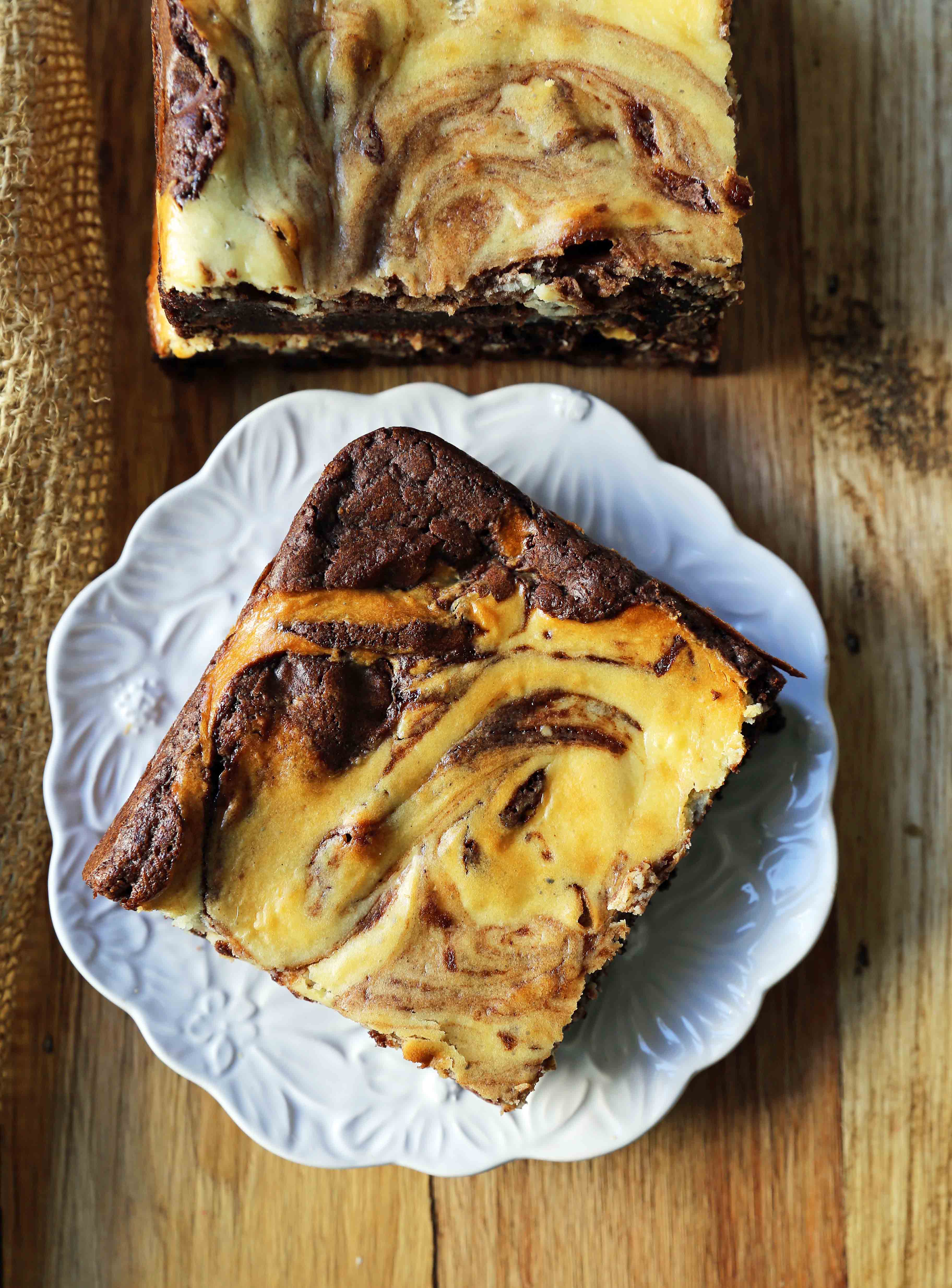 Cheesecake Brownies Homemade double chocolate chunk brownies with a sweet and tangy cheesecake swirl. Cheesecake and a Brownie in one dessert bar! Cream Cheese Brownies Recipe. www.modernhoney.com #creamcheesebrownies #cheesecakebrownies #brownies #cheesecakebrownierecipe #homemadebrownies 