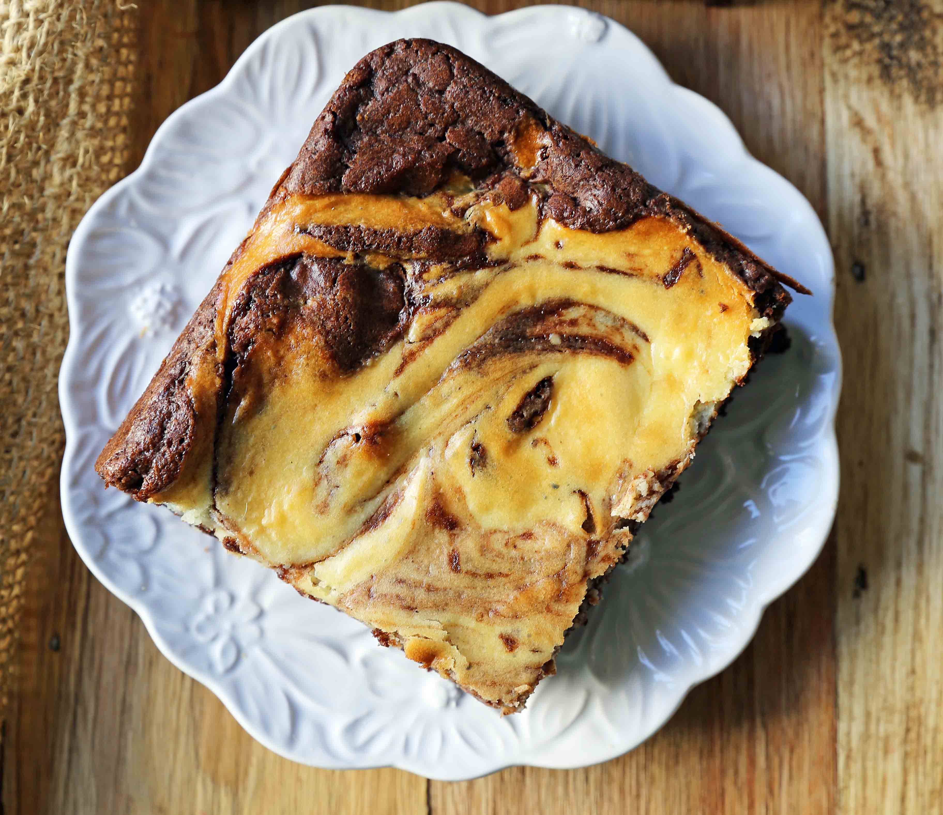 Cheesecake Brownies Homemade double chocolate chunk brownies with a sweet and tangy cheesecake swirl. Cheesecake and a Brownie in one dessert bar! Cream Cheese Brownies Recipe. www.modernhoney.com #creamcheesebrownies #cheesecakebrownies #brownies #cheesecakebrownierecipe #homemadebrownies