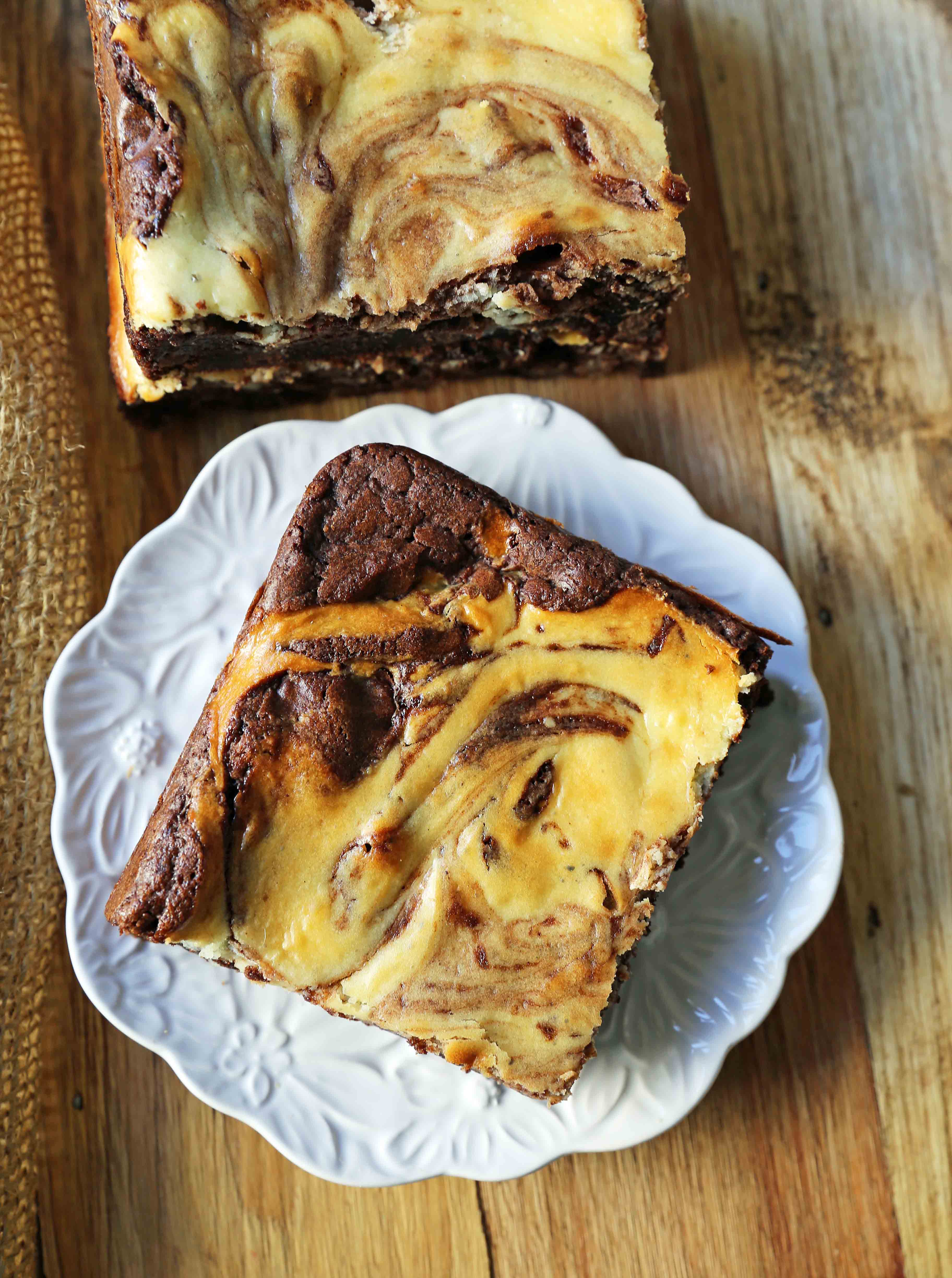 Cheesecake Brownies Homemade double chocolate chunk brownies with a sweet and tangy cheesecake swirl. Cheesecake and a Brownie in one dessert bar! Cream Cheese Brownies Recipe. www.modernhoney.com #creamcheesebrownies #cheesecakebrownies #brownies #cheesecakebrownierecipe #homemadebrownies