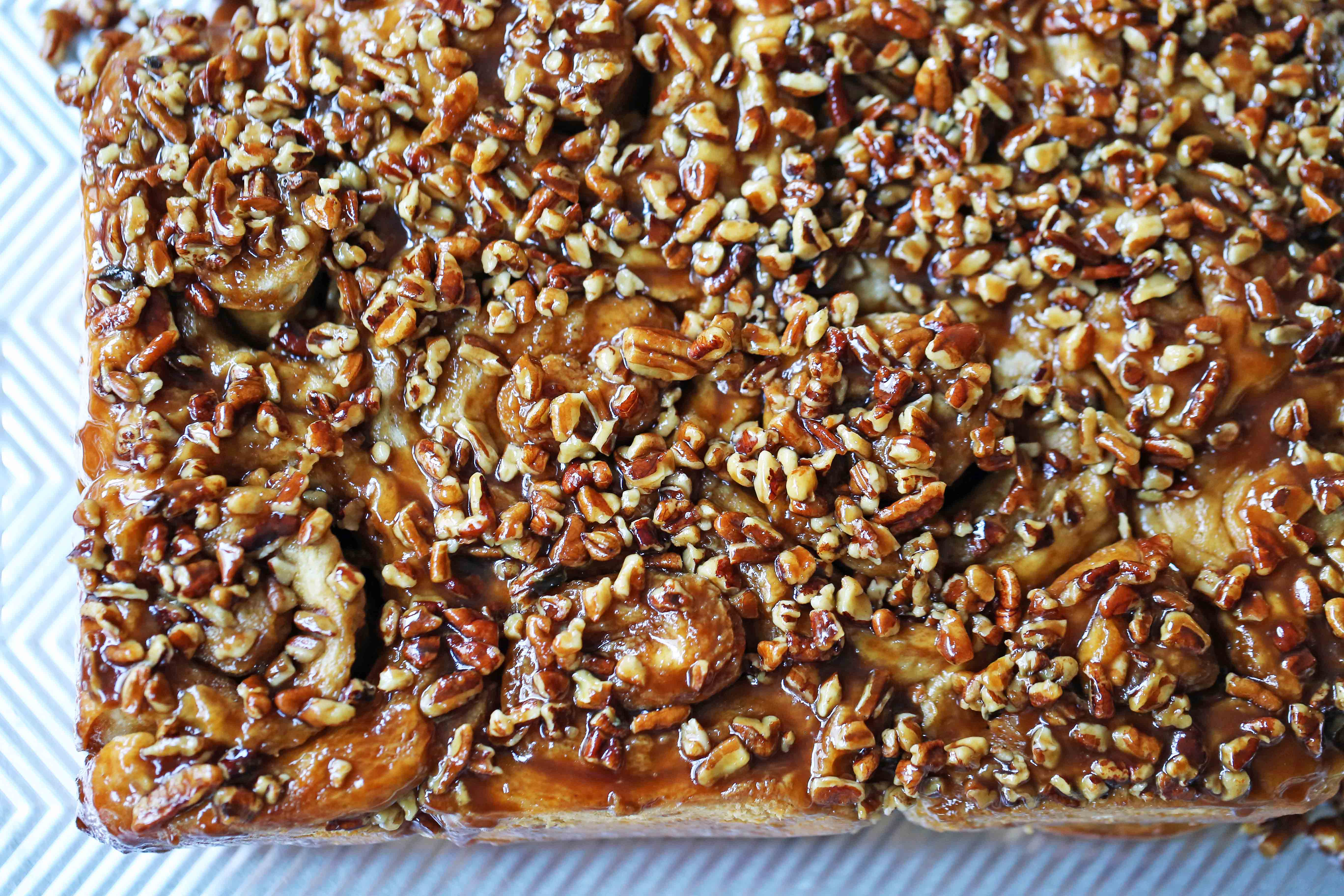 Caramel Pecan Rolls Homemade sweet rolls with rich caramel sauce and pecans. The perfect pecan sticky buns recipe! How to make homemade sticky buns from scratch. www.modernhoney.com #stickybuns #pecanrolls #caramelpecanrolls #caramelrolls #caramelstickybuns #pecanbuns