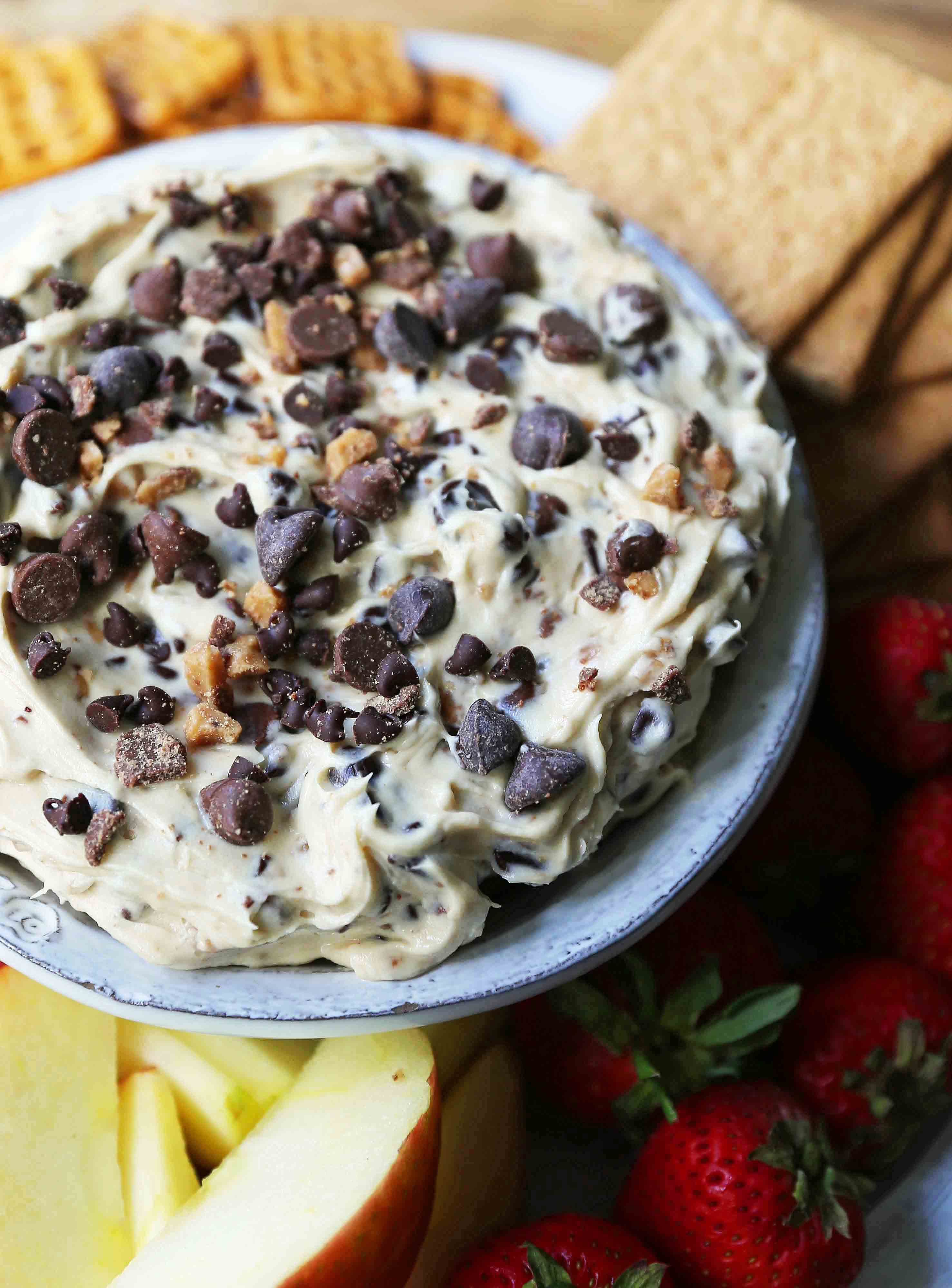 Chocolate Chip Cookie Dough Dip. A sweet cream cheese dip with chocolate chips and chocolate covered toffee bits. Perfect for parties and potlucks and always a crowd favorite! www.modernhoney.com #cookiedoughdip #chocolatechipdip #creamcheesedip #cookiedoughdip #chocolatechipcreamcheesedip #sweetappetizers