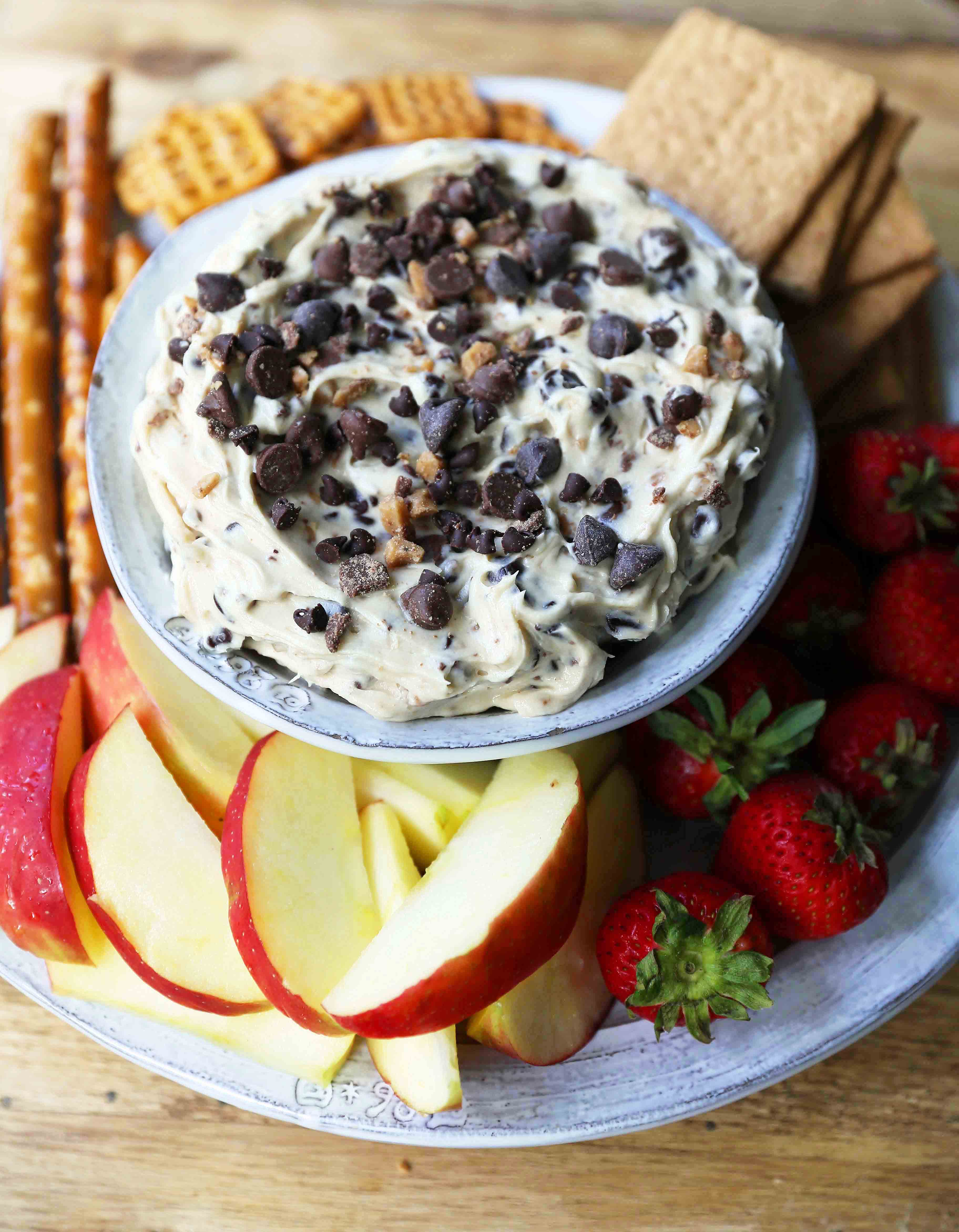 Chocolate Chip Cookie Dough Dip. A sweet cream cheese dip with chocolate chips and chocolate covered toffee bits. Perfect for parties and potlucks and always a crowd favorite! www.modernhoney.com #cookiedoughdip #chocolatechipdip #creamcheesedip #cookiedoughdip #chocolatechipcreamcheesedip #sweetappetizers