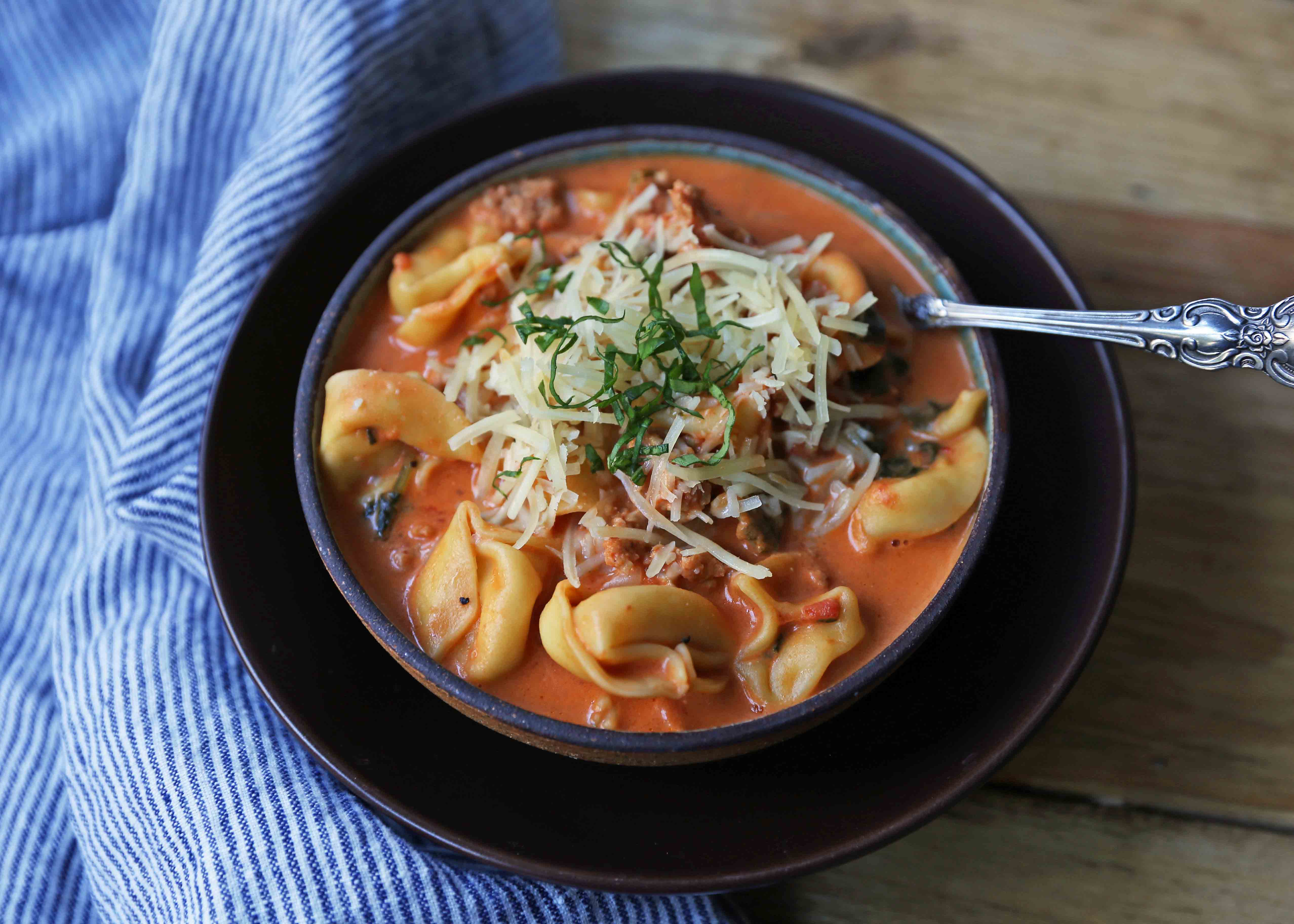 Creamy Sausage Tortellini Soup. A quick and easy 6-ingredient popular Creamy Sausage Tortellini Pasta Soup. A family favorite soup recipe! www.modernhoney.com #soup #souprecipe #sausagetortellinisoup #slowcooker #bestsoups